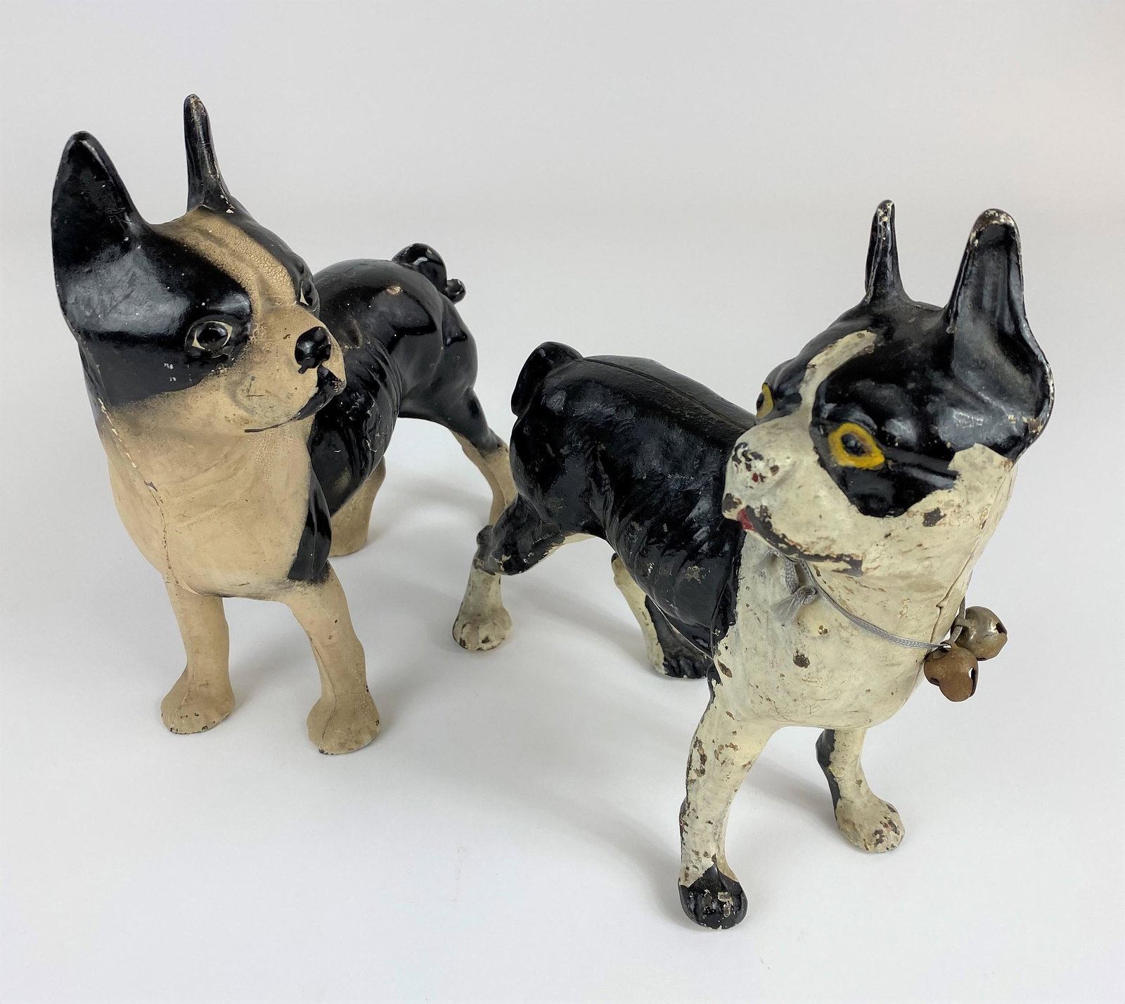 Pair of Painted Cast Iron Dog Doorstoppers: One containing bells around neck: 9.5" ht.