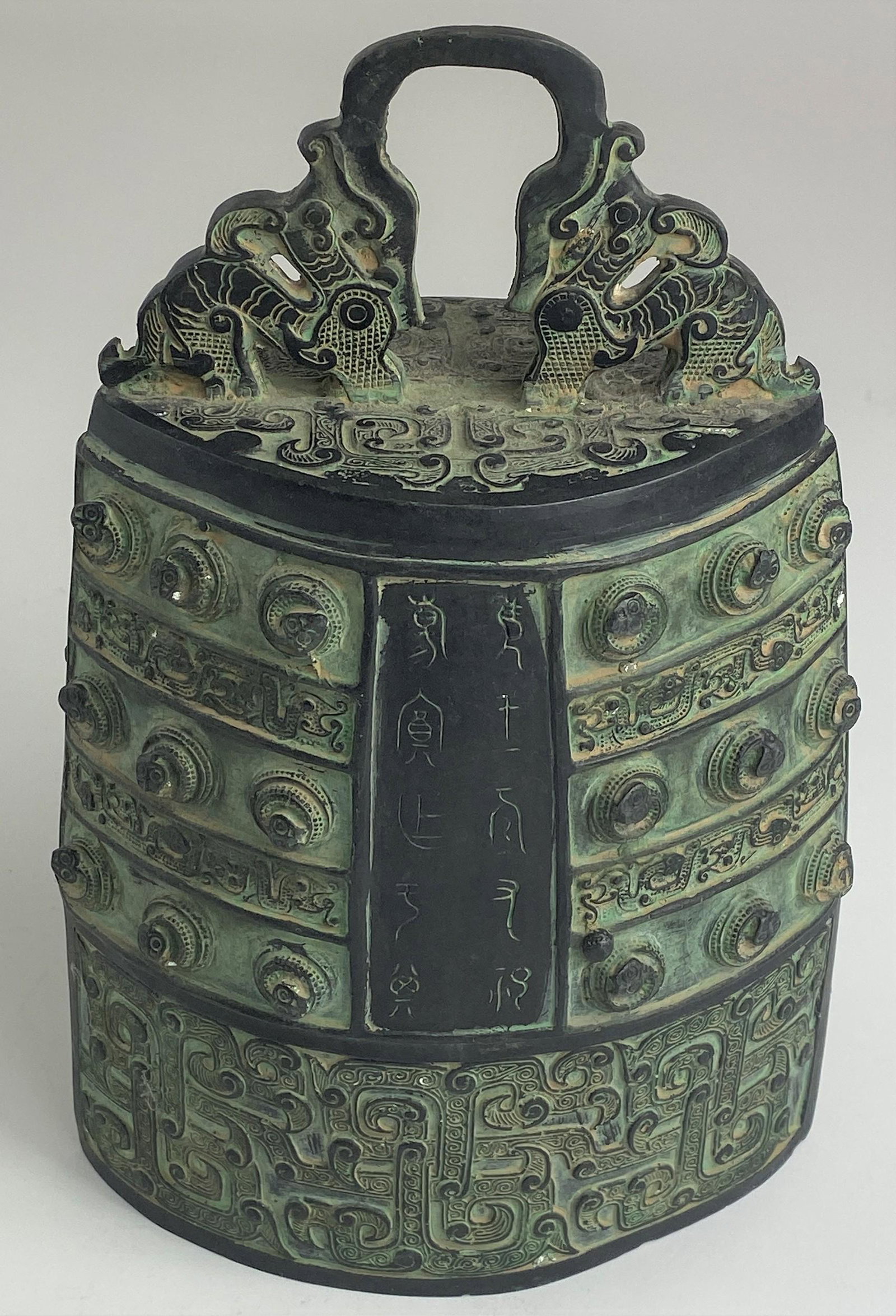 Chinese Archaic Style Bell: 20th century, modeled after a Shang bell in cast iron; ht. 11.25" x 4" dp. x 7" wd.