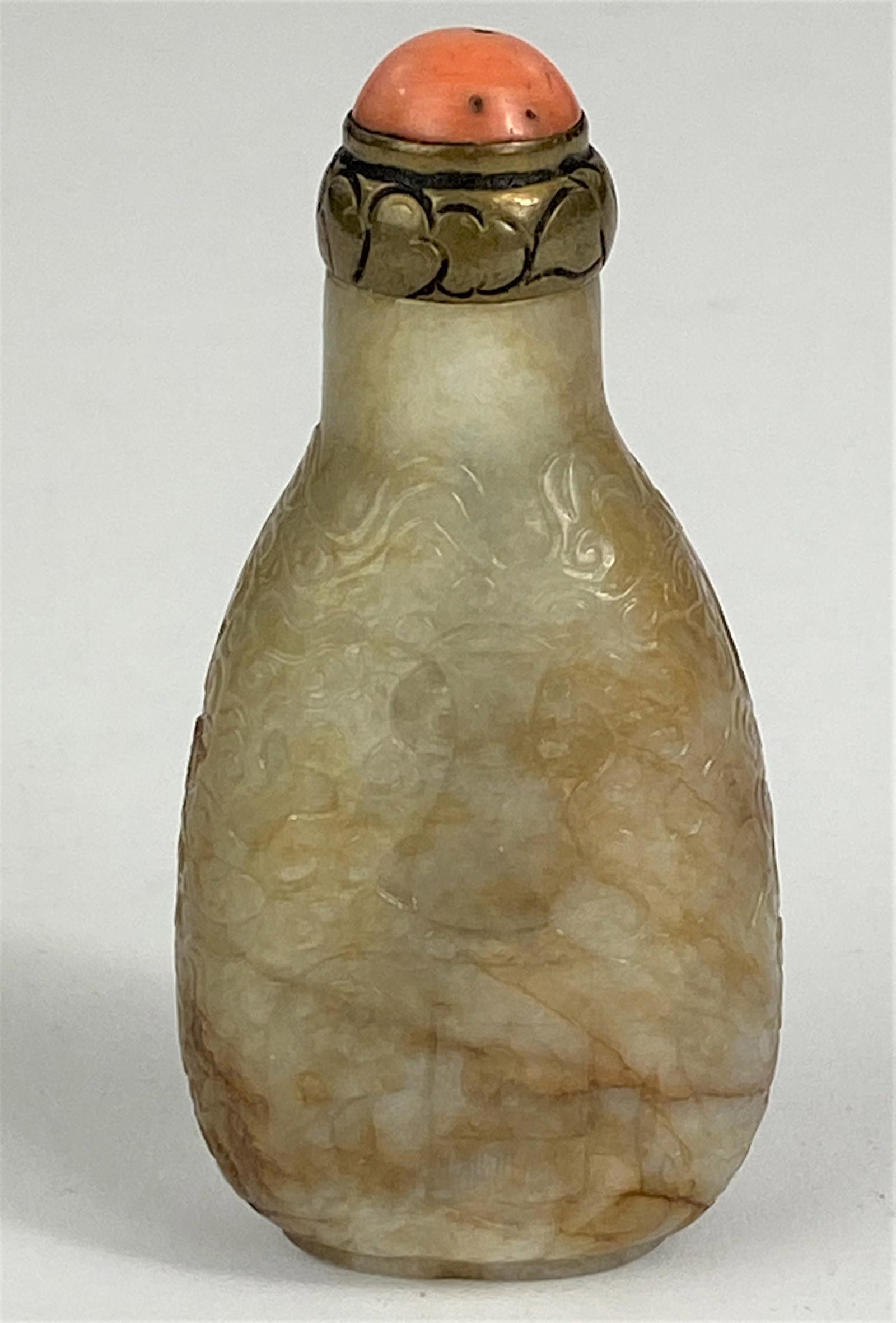 Fine Chinese Jade Snuff Bottle: A jade snuff bottle, 19th century or earlier, tapering to a slender neck and very well hollowed out, with low relief carving of clouds, vase and elephant, coral and brass cap; ht. 3". Ex Collection of