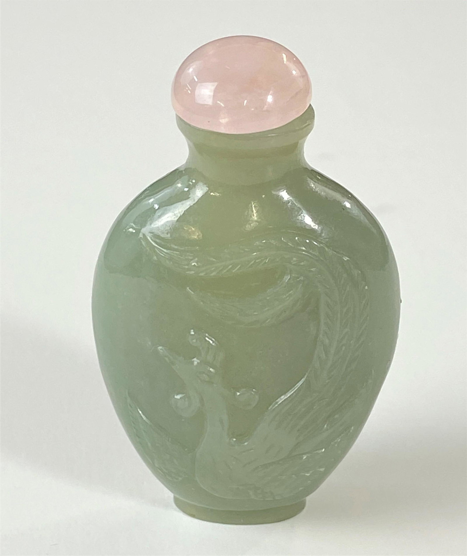 Chinese Snuff Bottle in Celadon Jade with Phoenix: A Chinese snuff bottle, diminutive size, with phoenix carved to relief; ht. 2.25". Ex Collection of the late Dr. Sylvan and Faith Golder, Cincinnati, OH