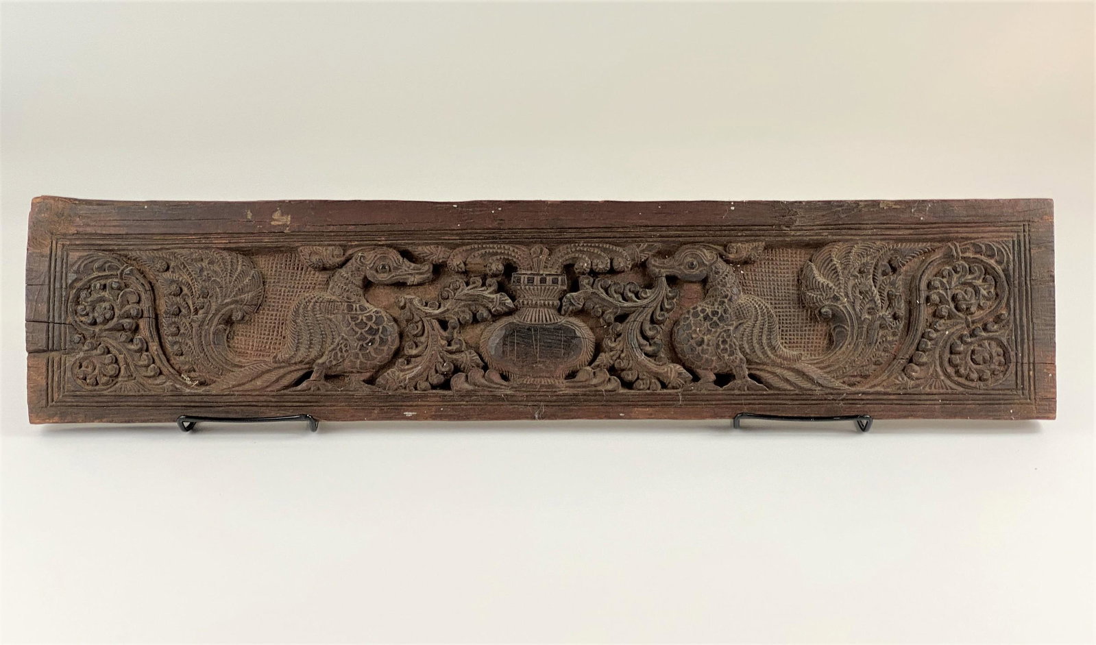 Indonesian Carved Wood Wall Hanging: Carved wood, early 20th century, depicting birds and urn with other stipple carved decoration; lg. 27".