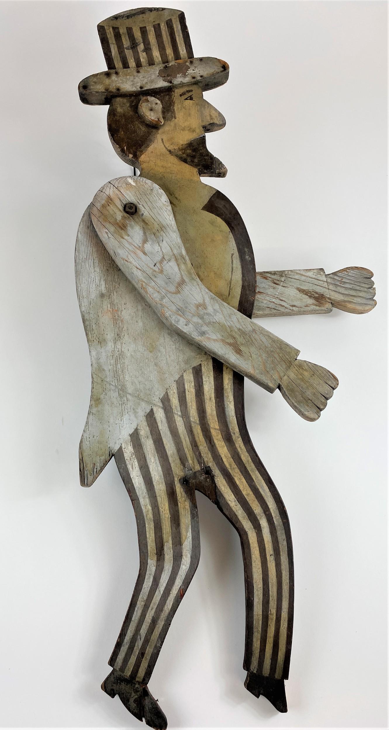 Folk Art Uncle Sam Carved and Painted Whimsy: Early 20th century, a carved and painted Uncle Sam figural whimsy, with moving arms; ht. 41".