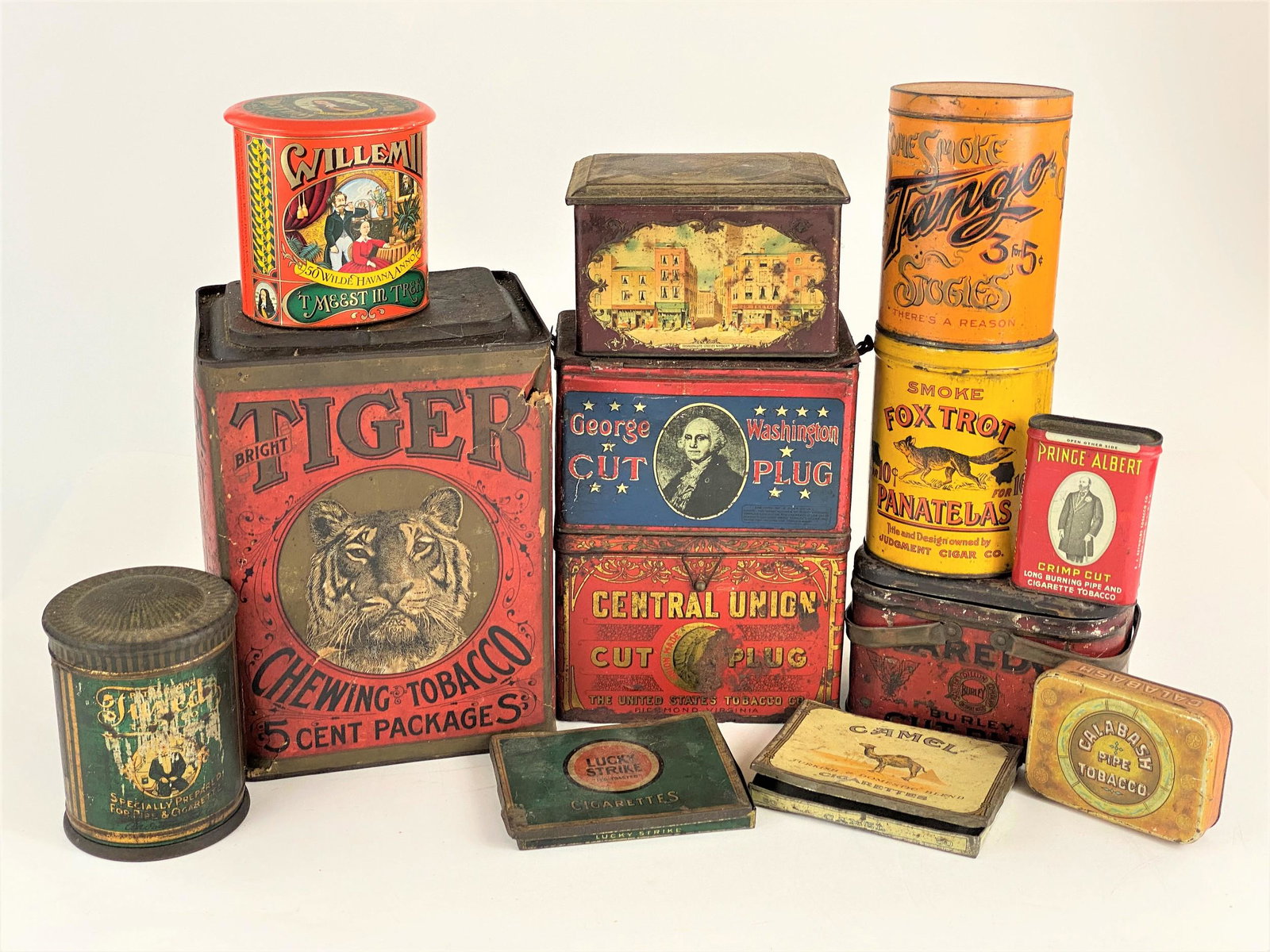 Collection of Tobacco Related Tins: A group of 13 tobacco-related tins, including tin cigarette cases, cigar tins, and cut plug of various brands; tallest ht. 11".