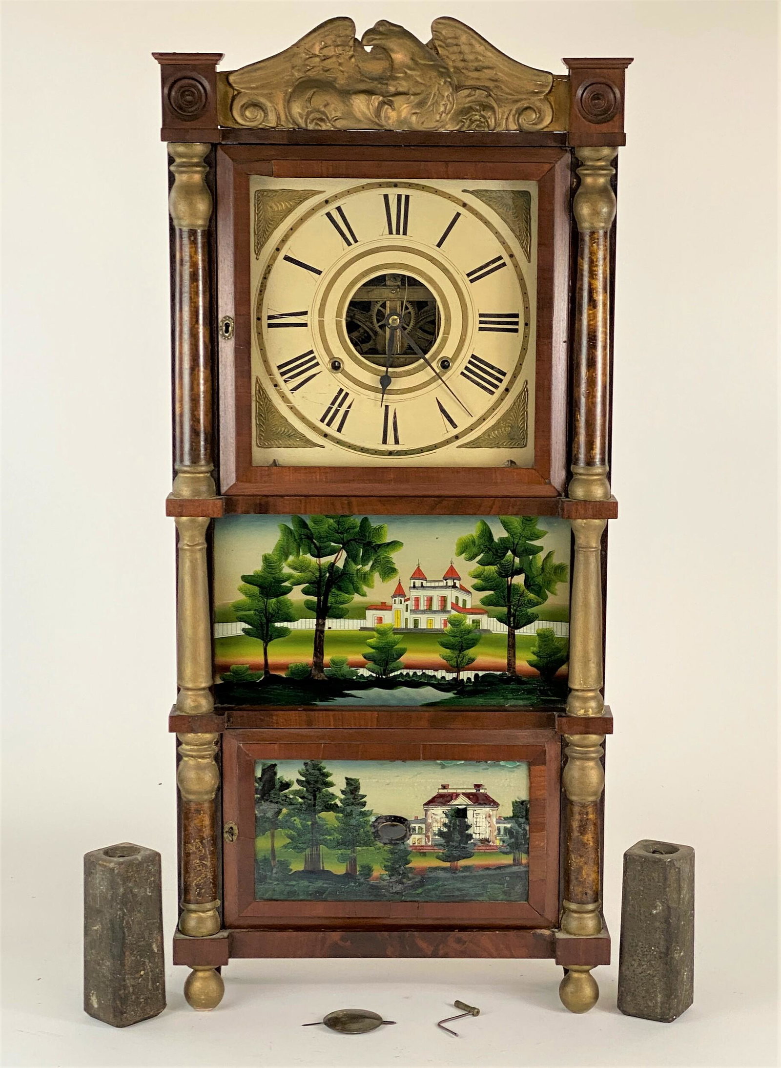 Birge, Mallory & Co. Triple Decker Patriotic Shelf: 19th century, a triple decker shelf clock, with pair of reverse glass panels to lower section, grain painted and gilt columns, with eagle top; ht. 38".