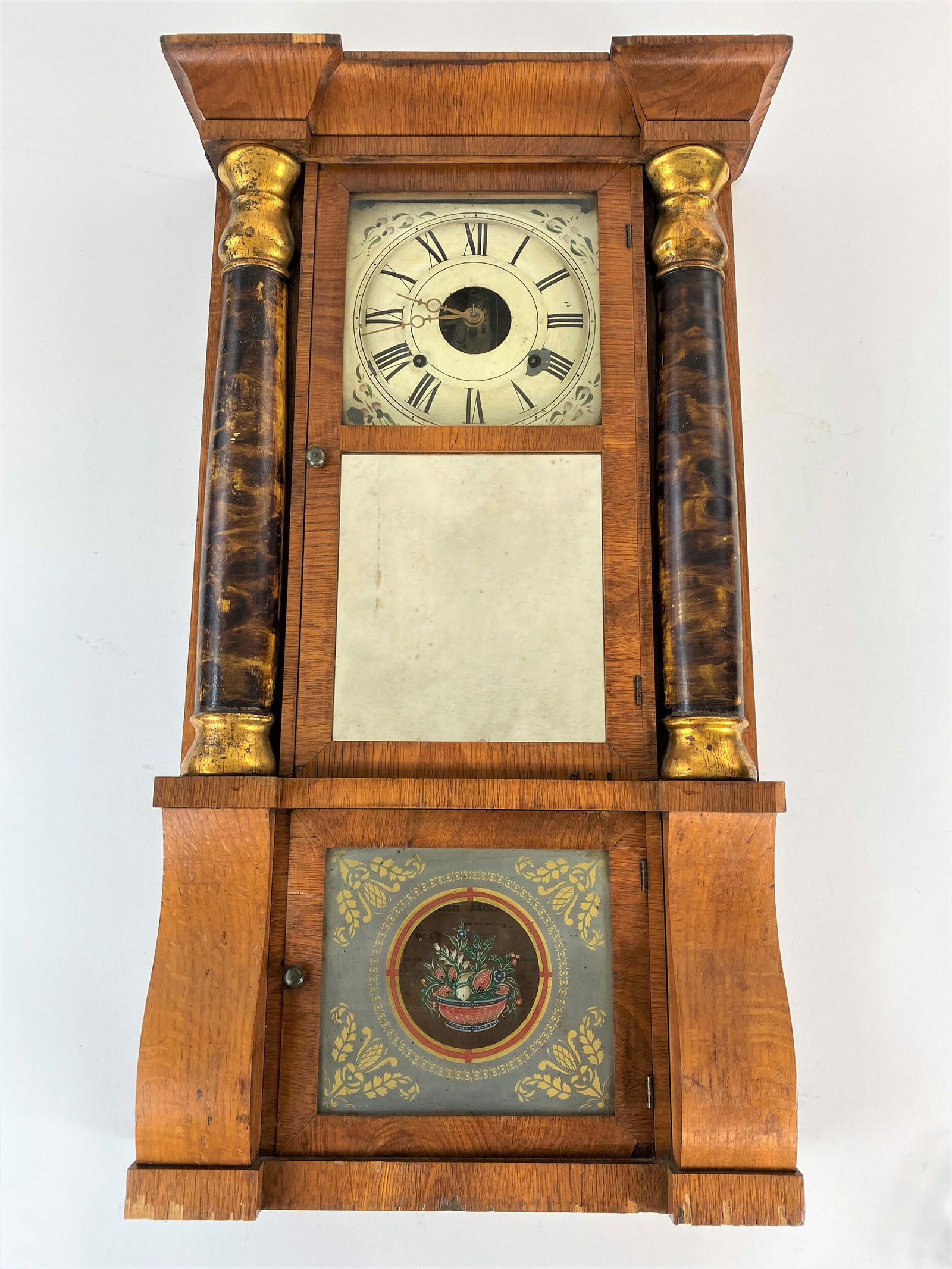 Seth Thomas Columned Shelf Clock: 19th century, a Seth Thomas shelf clock with floral glass panel, grain painted and gilt columns, label to interior and old weights; ht. 32.5".
