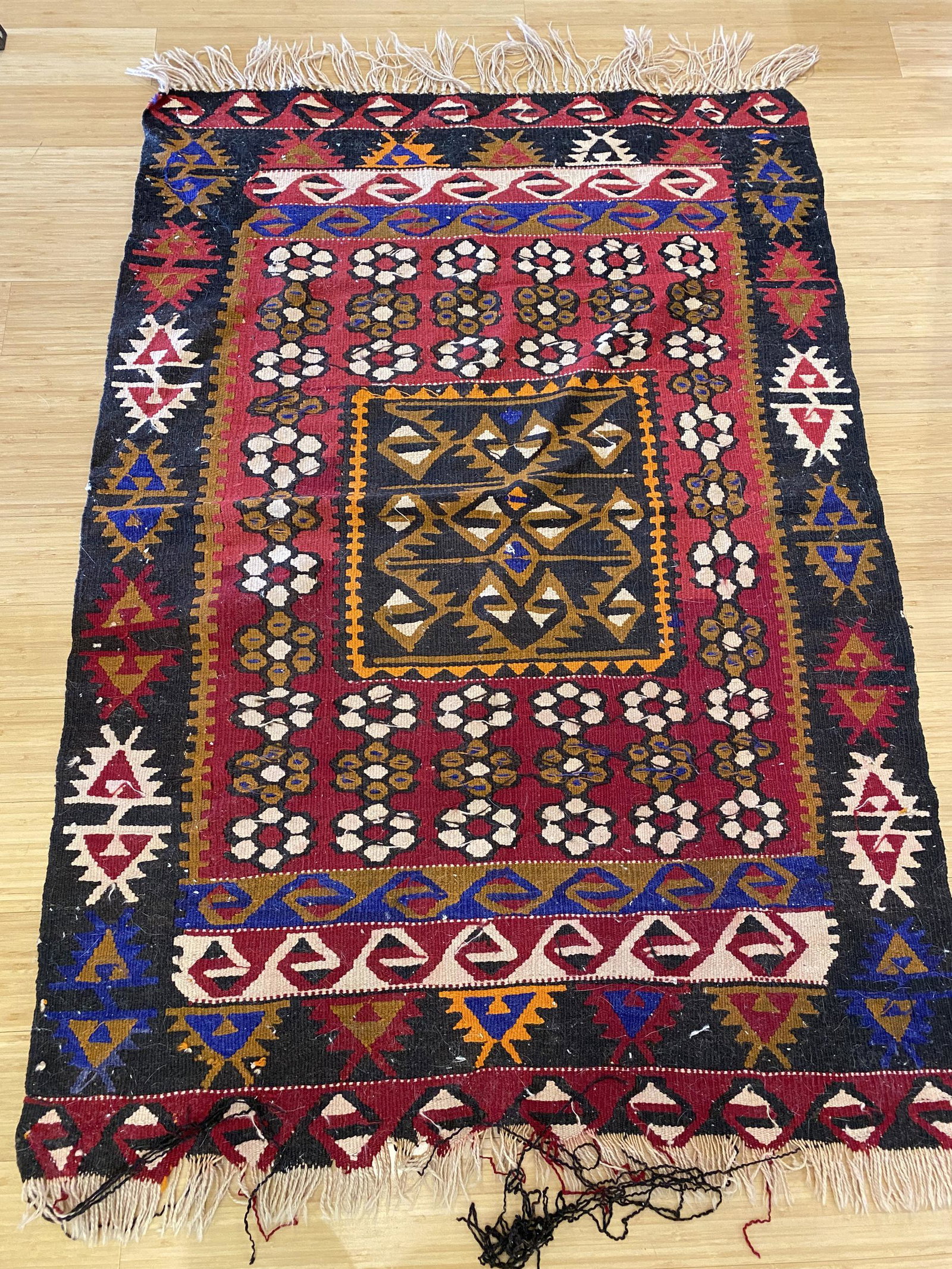 Three Large Area Rugs: A pair of geometric rugs and one Persian rug; longest 112" x 38".