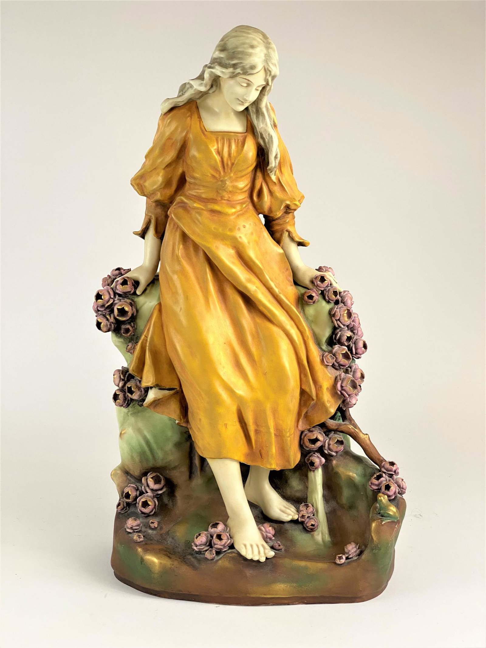 Amphora Pottery Figural Group, Woman in Garden: Amphora, Austria pottery, a large figural group depicting woman among flowers, with vase-like vessel behind, marked to underside; ht. 22.5".