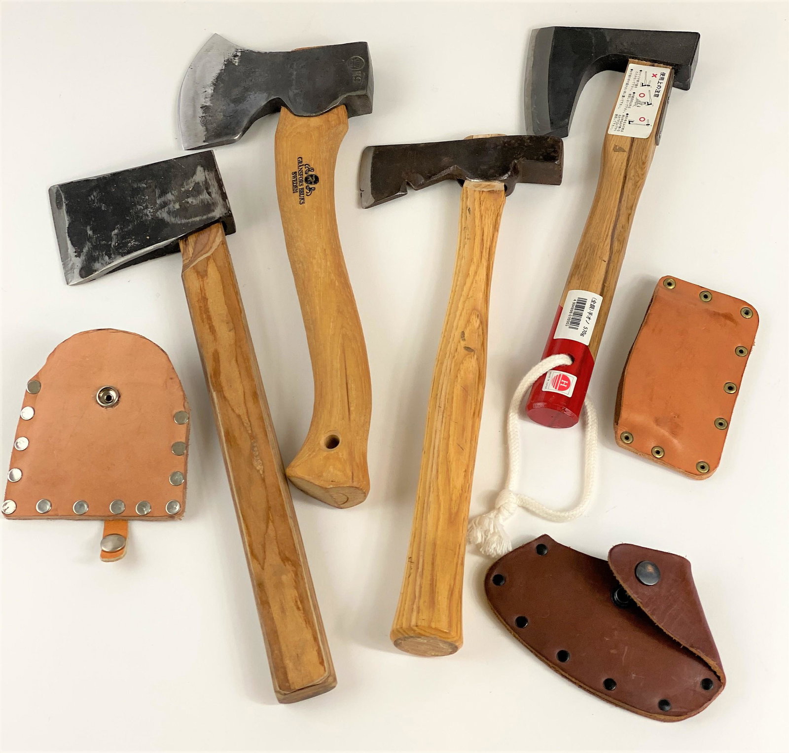 Group of Hatchets: 4 hatchets, including a Japanese example, a Gransfors-Bruks hatchet and two other unidentified, each with cover.