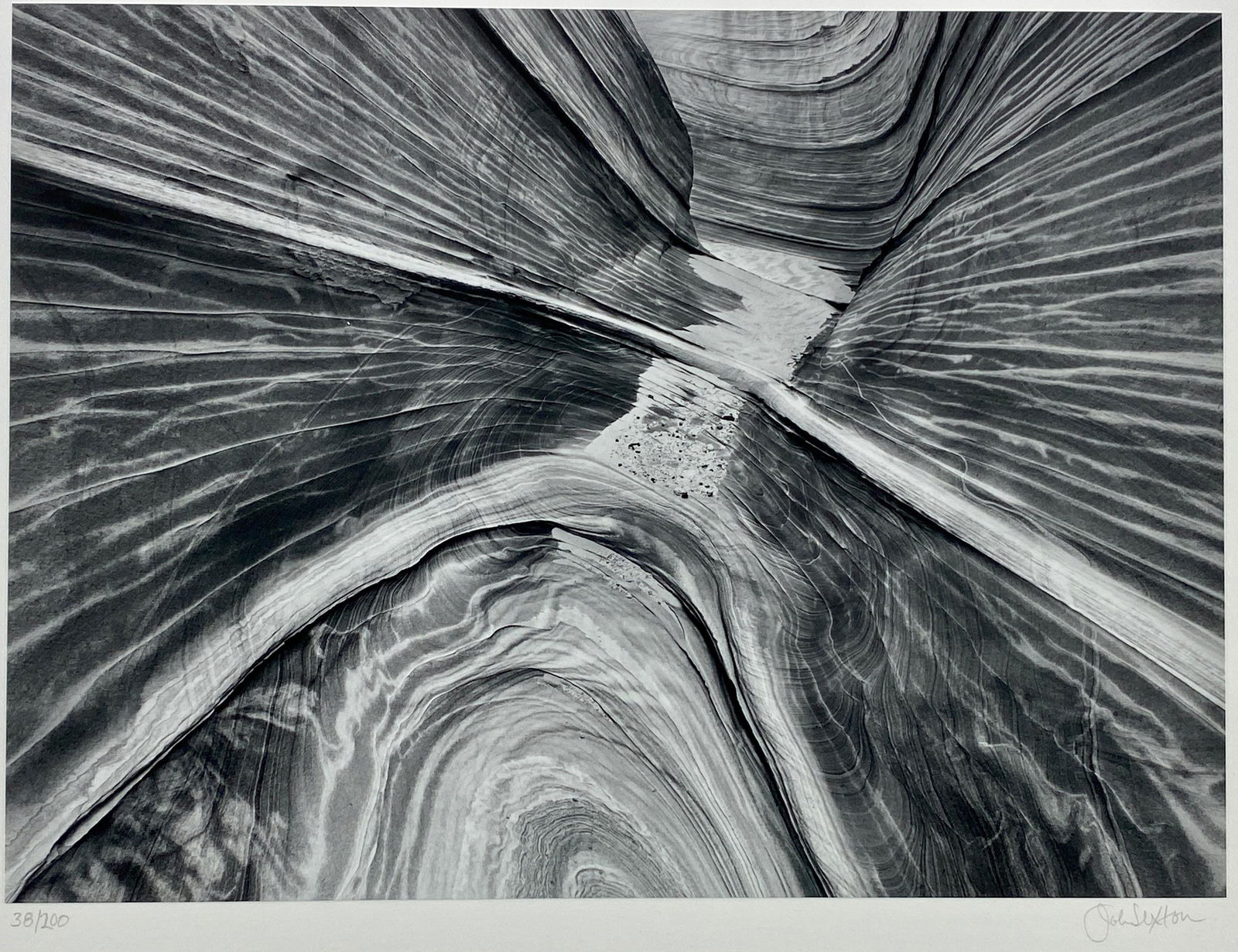 "Sandstone Narrows" by John Sexton: "Sandstone Narrows" by John Sexton John Sexton (American, b. 1953). A silver gelatin photograph, signed and numbered 38/200 in margin, with photographer's label to verso; 9.5" x 13".Sexton worked for