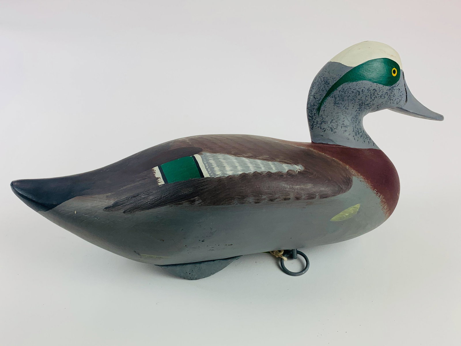 "Drake Widgeon" Decoy by R. Madison Mitchell: Carved and painted "Drake Widgeon" decoy by Madison Mitchell, inscribed to the bottom by the artist, unsigned; 15" lg. x 7.5" ht.