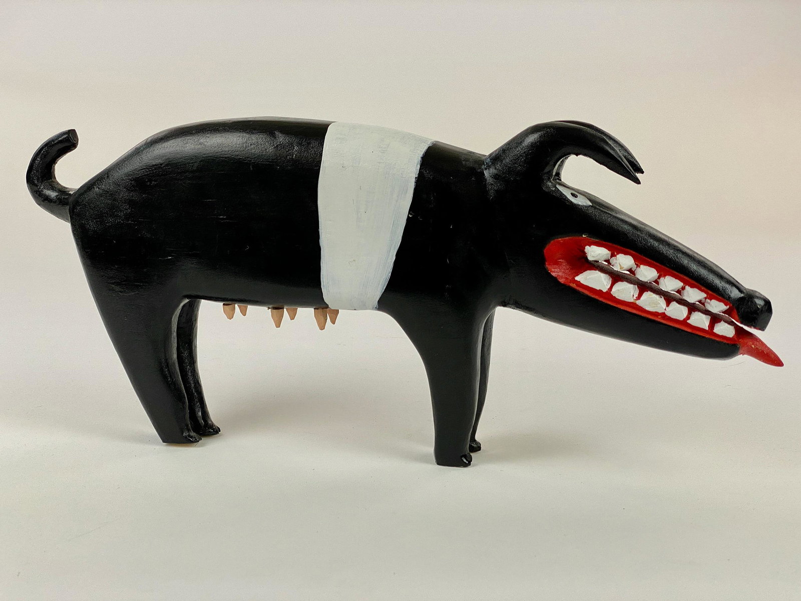 Minnie Adkins (KY), Carved Black and White Pig: Minnie Adkins (Kentucky, 1934), Folk Art Carved Black and White Pig. A nicely carved Minnie Adkins pig with six udders to the underside and a tongue sticking out, in black and white, signed and dated 