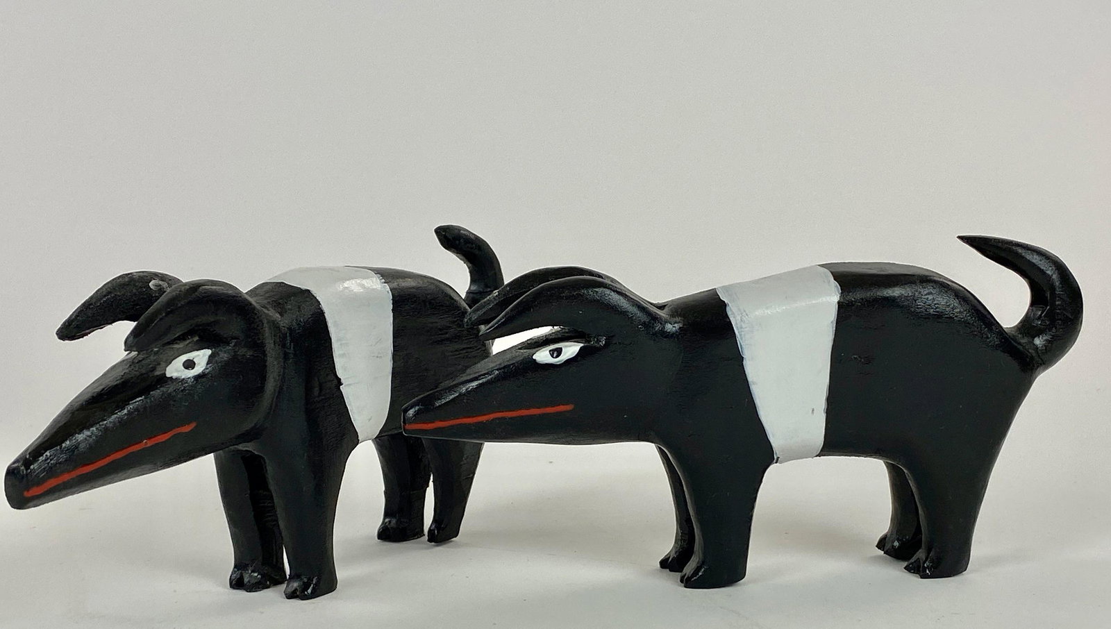 Folk Art Carved Piglets by Minnie Adkins: A diminutive pair of charming carved pigs, unsigned but decidedly in the artist's (Minnie Adkins) hand, each measuring 3.5" ht. by 7" lg. From the collection of Dr. Gerald and Barbara Theisen, Georget
