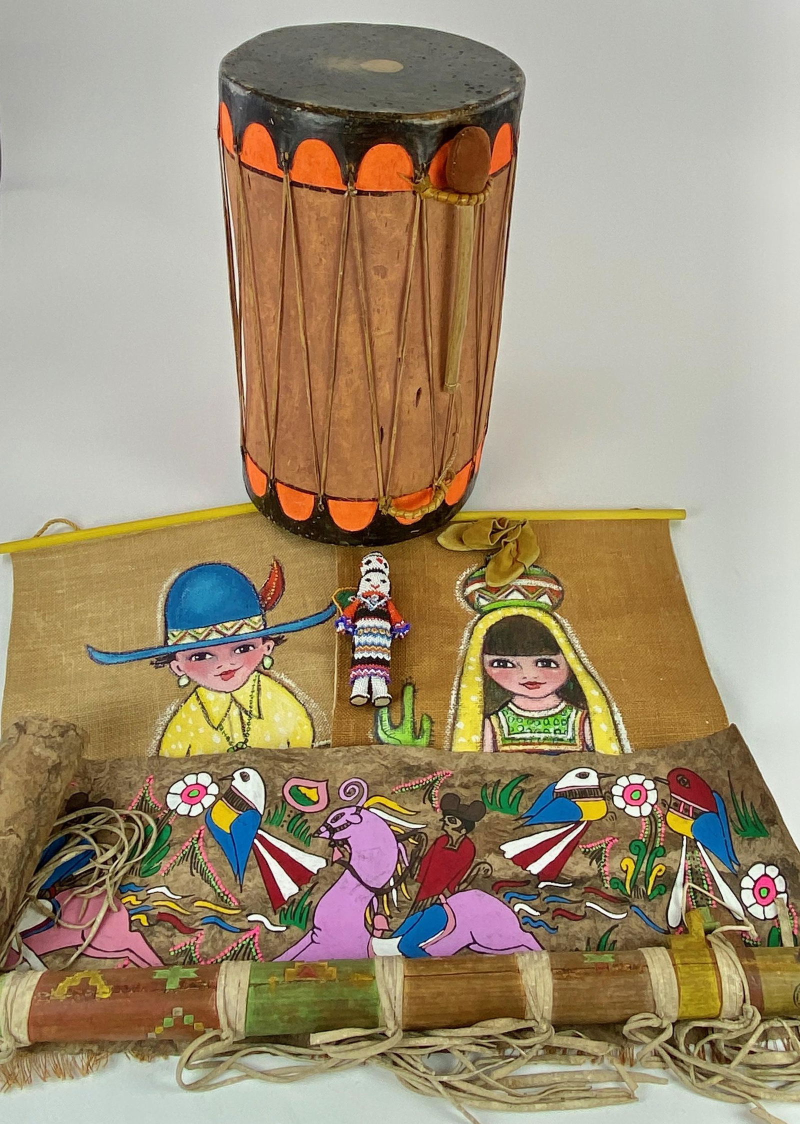 Large Collection of Southwestern Objects: A group of Southwestern decorative arts, including a painted drum, a hide painting, a miniature baby's pair of moccasins, a beaded doll, a Katsina painted figure, a polychrome painted pole, a pair of