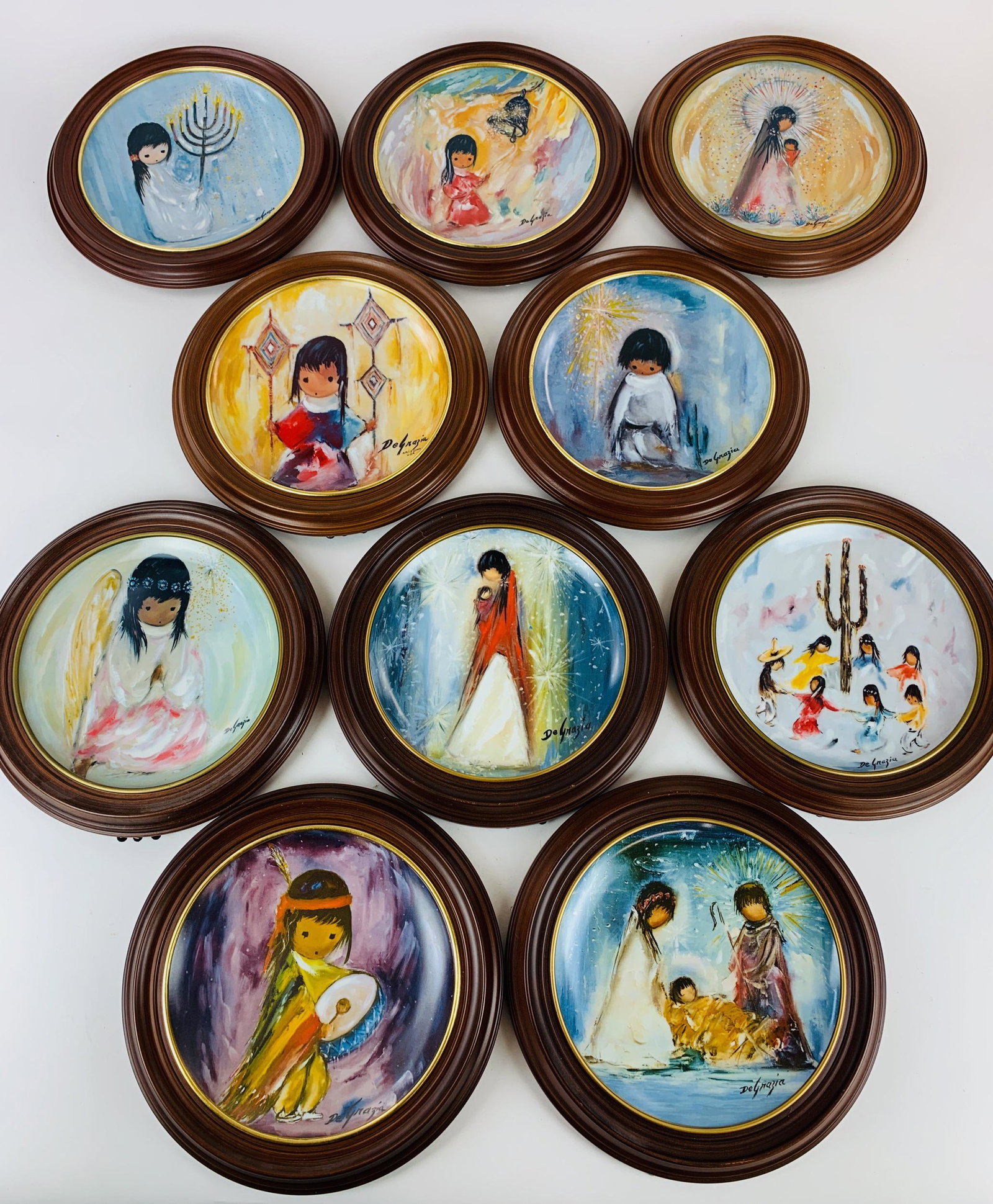 Collection of Ted DeGrazia Framed Limited Plates: A limited edition set of 10 plates, each with transfer DeGrazia subject, and marking to underside of each, 4224/10000; each diameter 12.5".