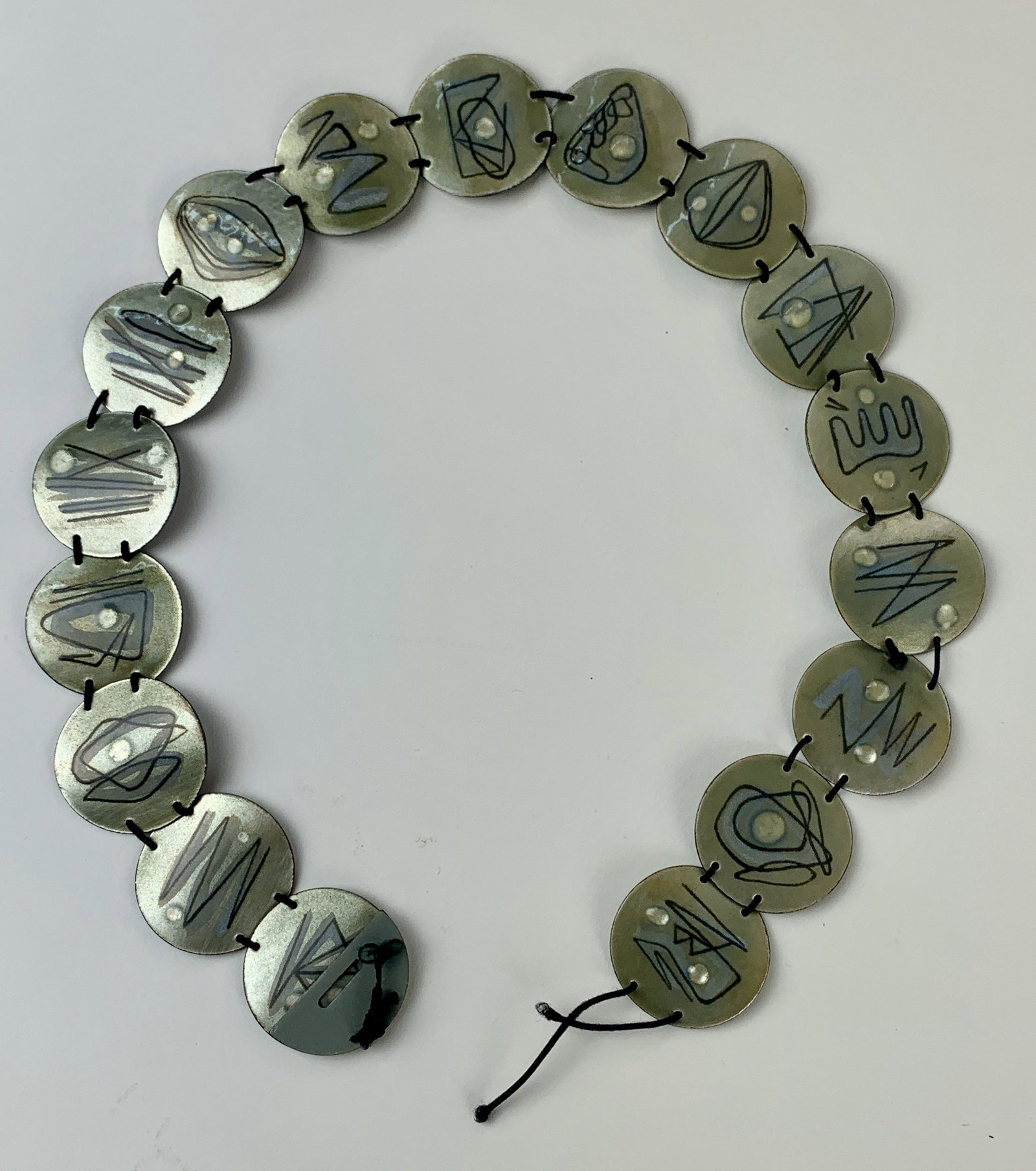A Silver Enameled Belt by Miriam Peck (Cleveland): A Silver Enameled Belt by Miriam Peck (Cleveland, 1910-1984). Silver and enamel work, a belt consisting of circular roundels with string; overall lg. 23". Miriam Peck was a pioneering and innovative C