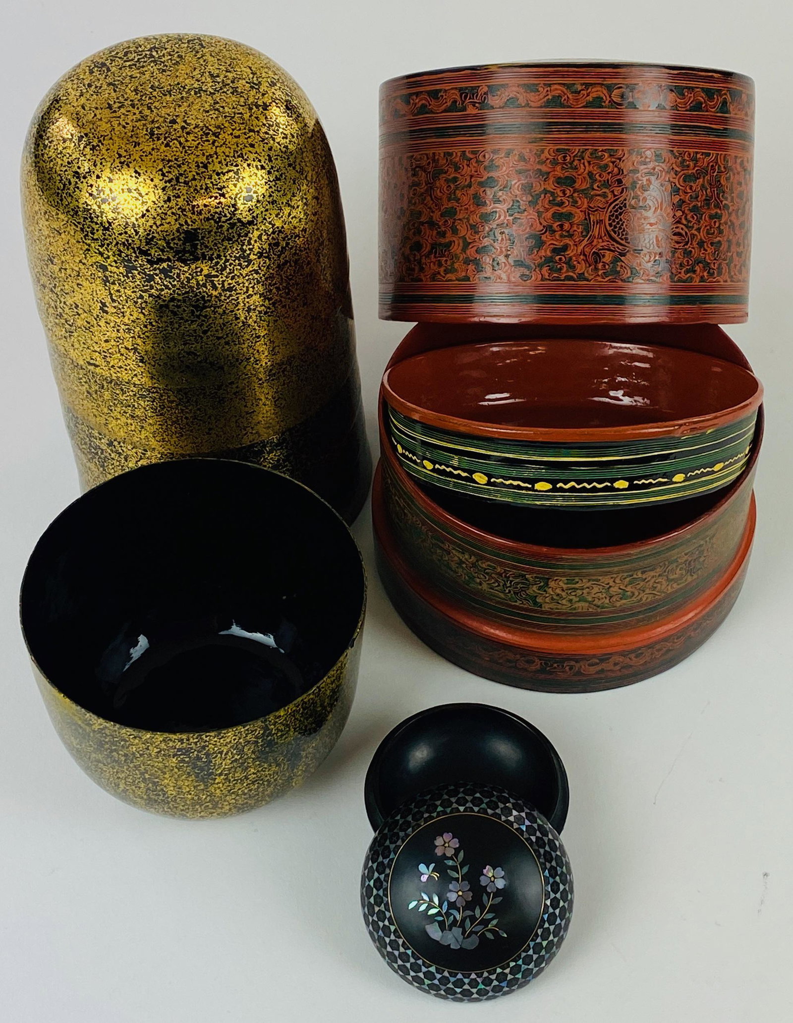 Chinese and Japanese Lacquer Wares: Including a group of 6 thin and gold splashed lacquer bowl, a cover lunch box, and finally a lacquer and mother of pearl small circular box; tallest ht. 4.25".