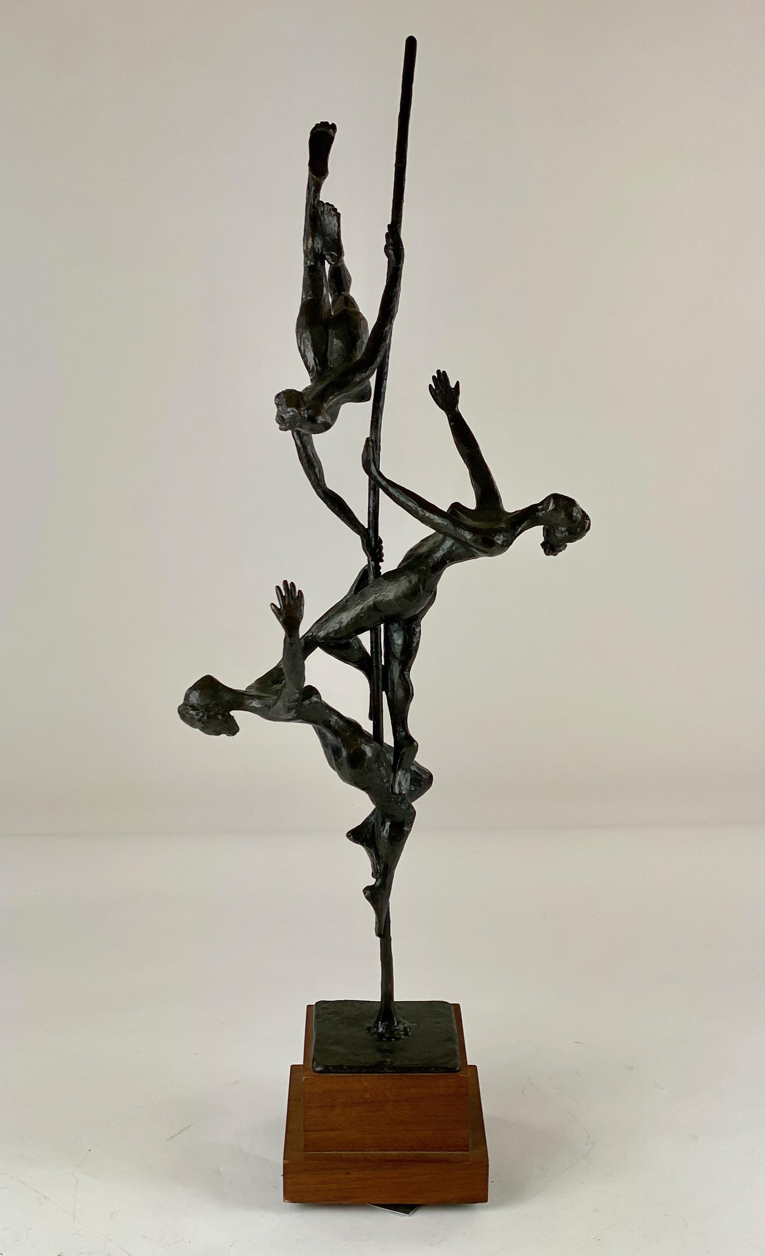 Gerald Fellman Bronze: A mid-century bronze on turning base, finely cast to reveal three figures on balancing pole signed near base; overall ht. 30.5".