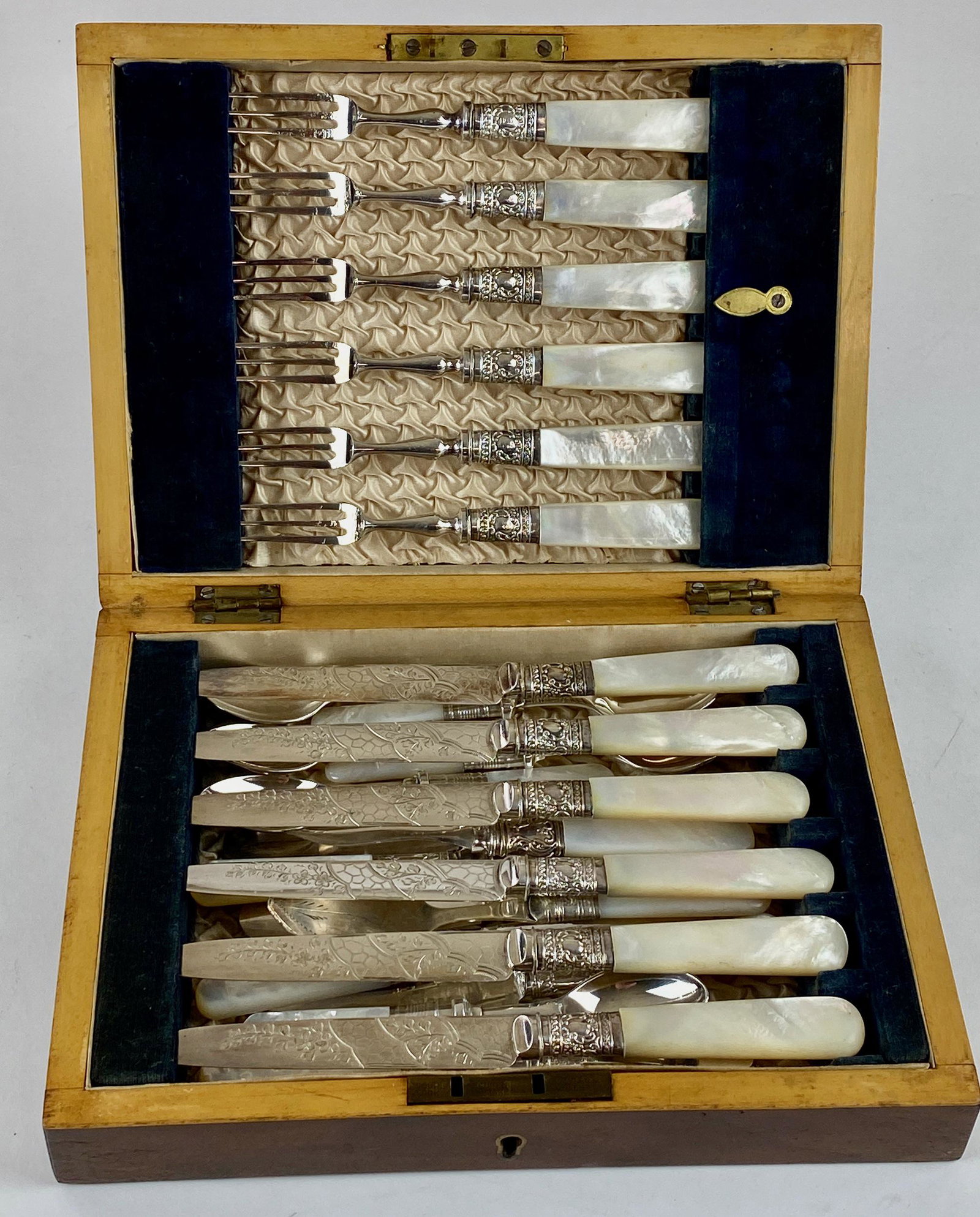 Rare Mother of Pearl and Plated Luncheon Set: A boxed "luncheon" set of mother of pearl and silver plated flatware, including 6 knives and forks, as well as 6 smaller spoons and knives, all housed in box with brass plate. Box measures 6.75" x 9.2