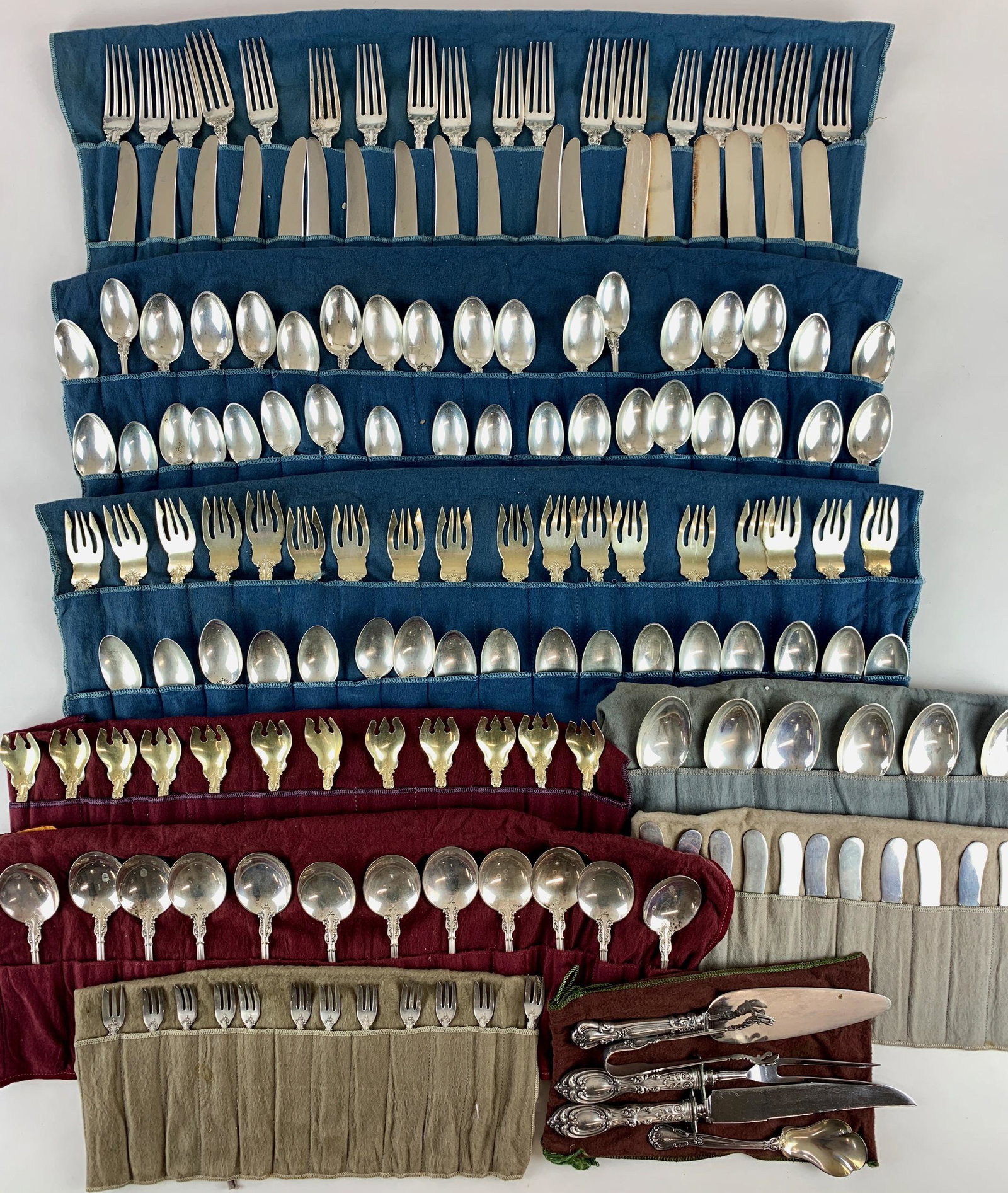 Large Set of Chantilly Sterling Flatware: Including 166 pcs. of Chantilly pattern sterling flatware. With 18 forks, 18 knives (not weighed), 12 gold wash salad forks, 24 smaller spoons, 12 long handled spoons, 12 all-sterling butter knives, 1