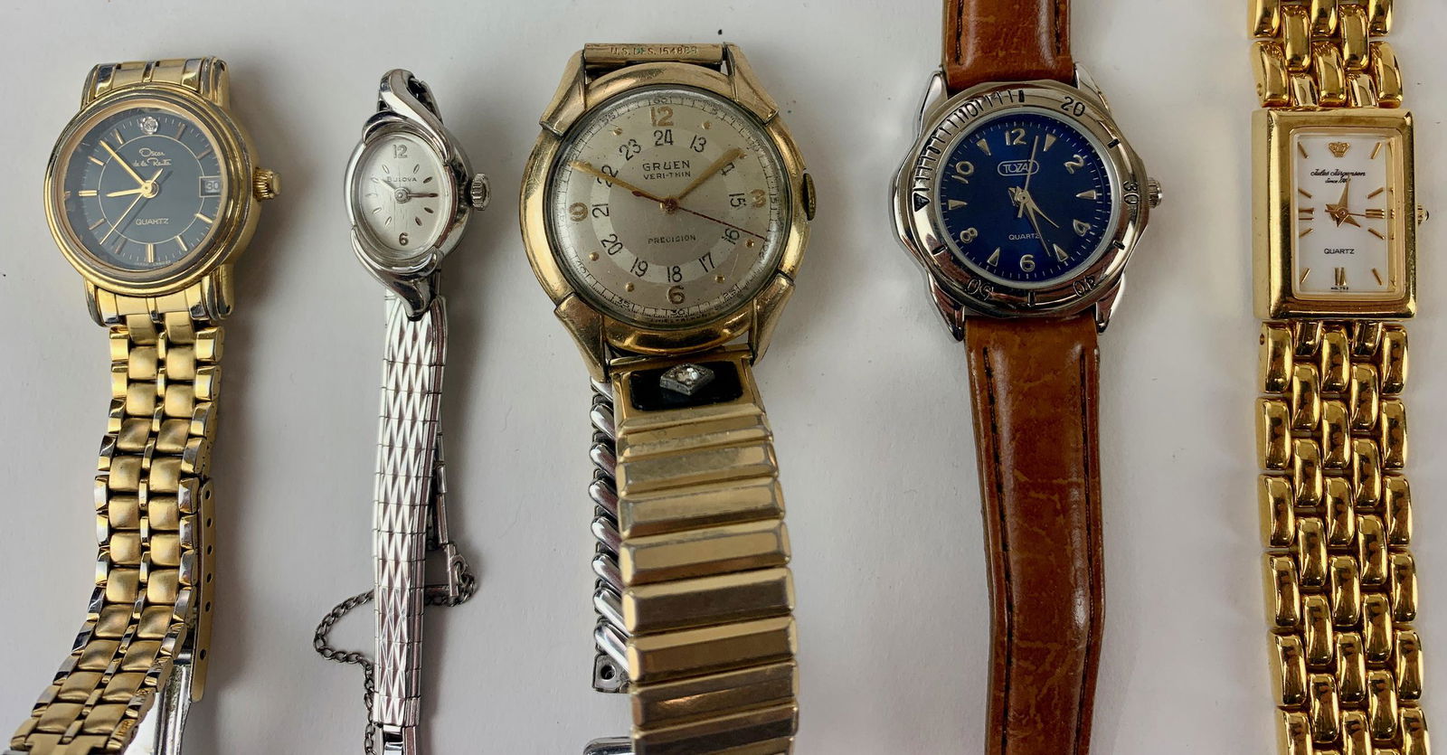 Five Wristwatches by Various Makers: Including wristwatches by: Jules Jergensen, Oscar de la Renta, Bulova, Tazaj, and a Gruen Veri-thin.