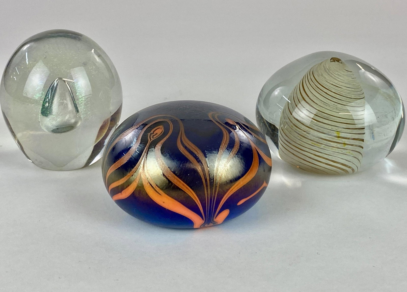 Eickholt, Sweet, and W.E. Porter Paperweights: Group of three (3) artist signed paperweights. All signed to bottom: W.E. Porter (1978), Eickholt (1977), and Doug Sweet (undated). Largest 3.5" in diameter. From the Estate of Harold and Miriam Prigo