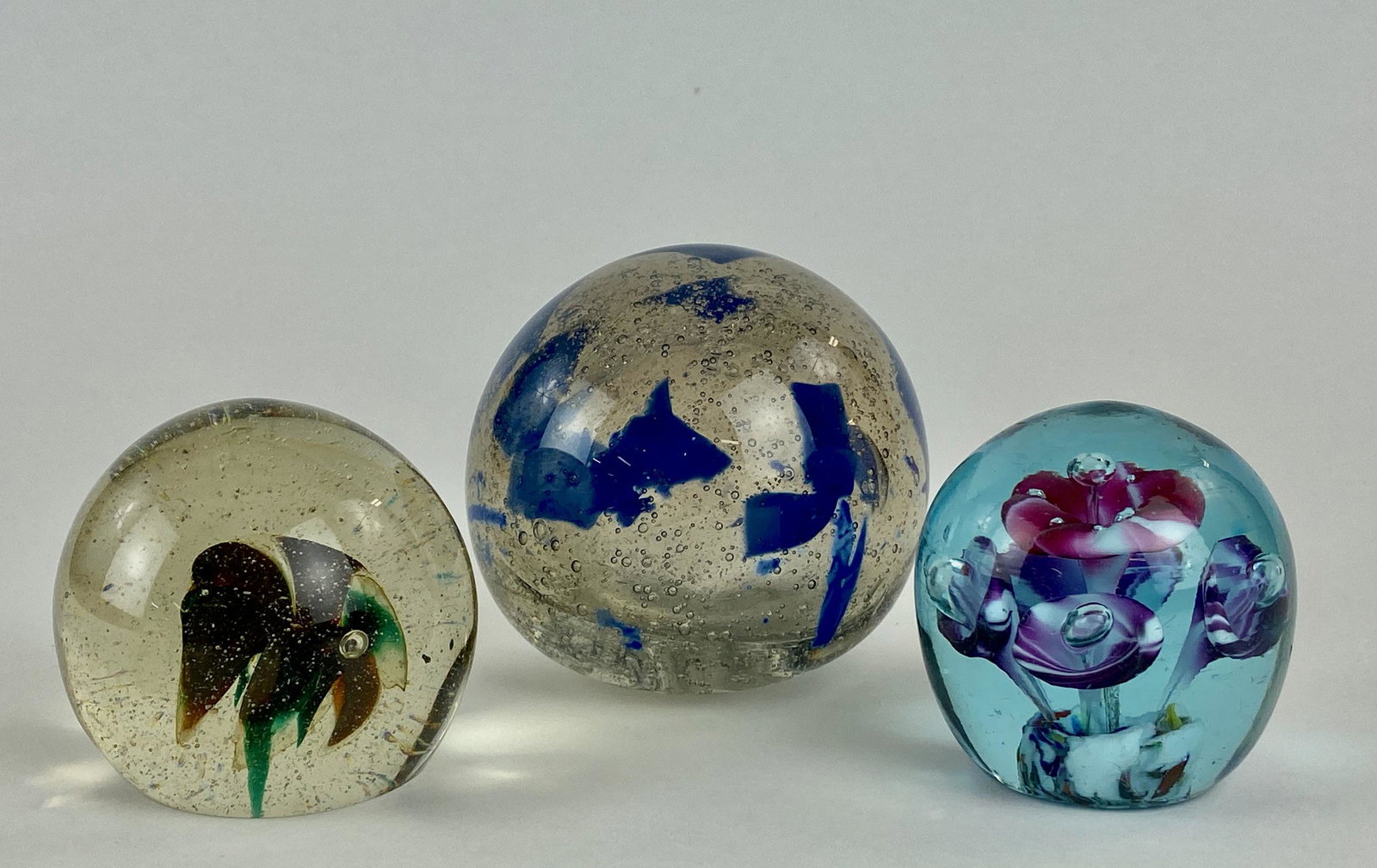 Three Unsigned Artglass Paperweights: Three (3) orb shaped, blown glass weights. Largest 3.25" ht. From the Estate of Harold and Miriam Prigozen, Dayton, OH.
