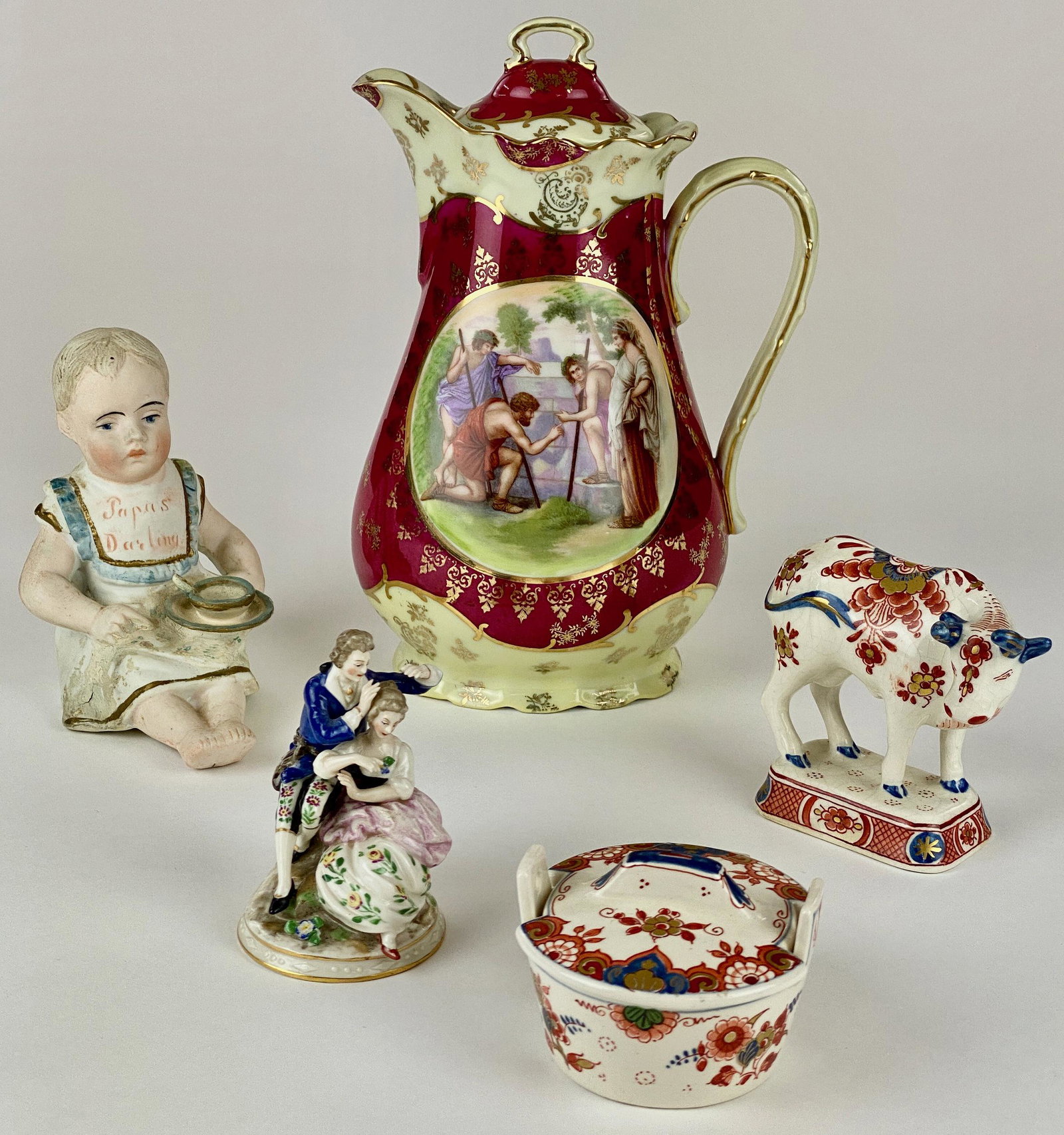 Royal Bavarian, Delft and Other Porcelains: Including a Royal Bavarian pitcher, a pair of Delft works, a porcelain figural group, and finally a German bisque "Papus Darling" doll, model #3987; largest ht. 9". From the Estate of Harold and Miria