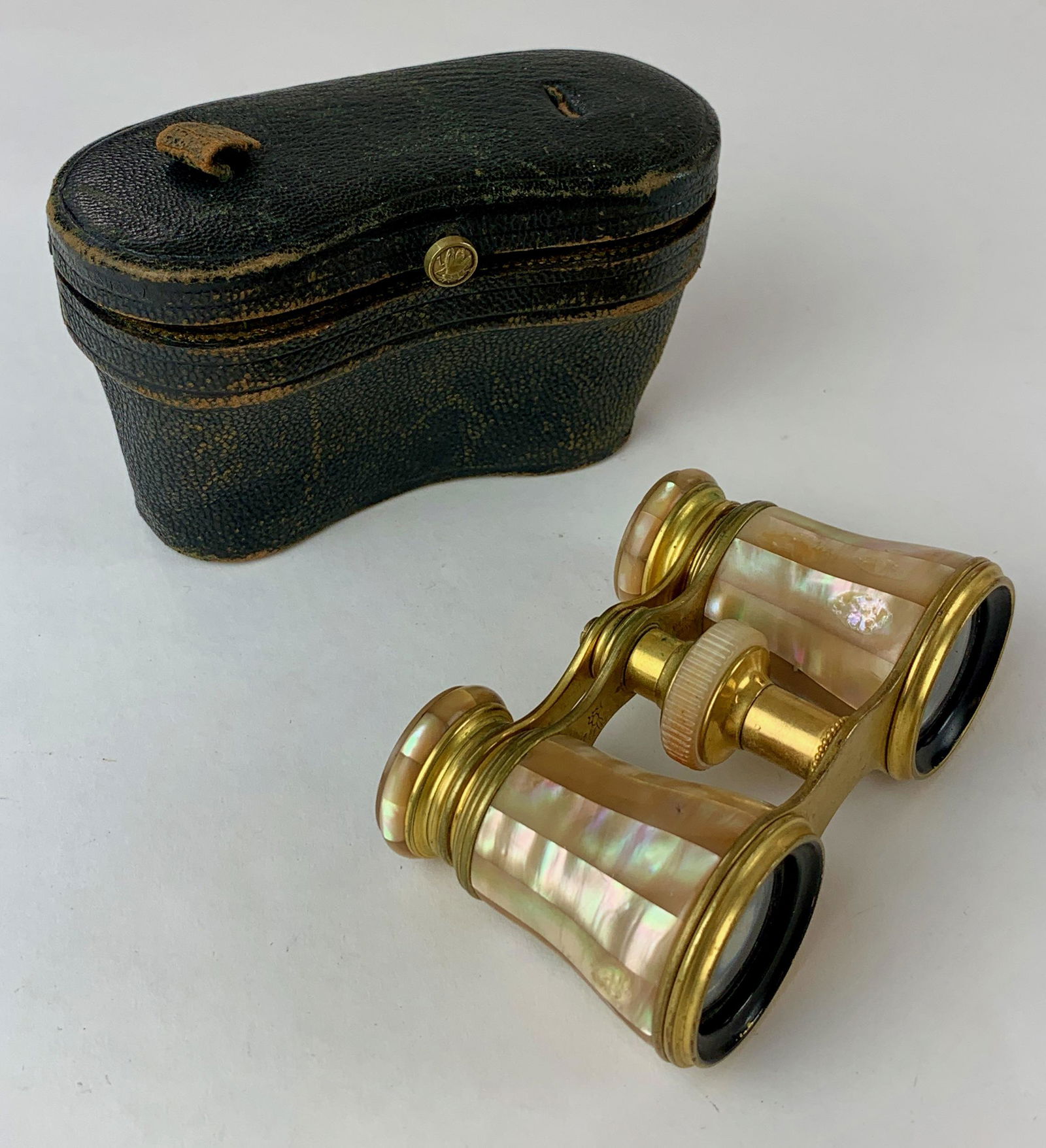Cased Pair of Lemaire Opera Glasses: Mother of Pearl and brass opera glasses by Lemaire, in leather button case; ht. 2.75".