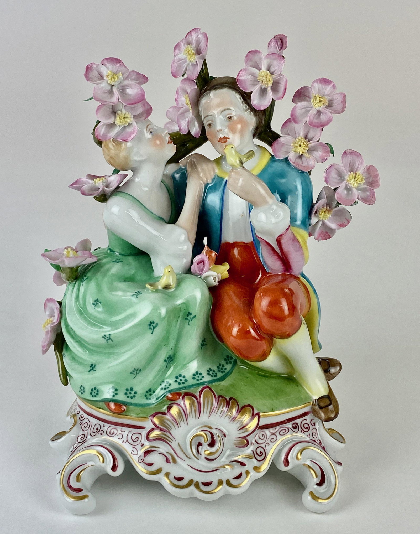 Herend Porcelain Figural Group: A porcelain figural group with courting couple, marked for Herend to underside, floral splay to the peak. ht. 7" From the Estate of Harold and Miriam Prigozen, Dayton, OH.