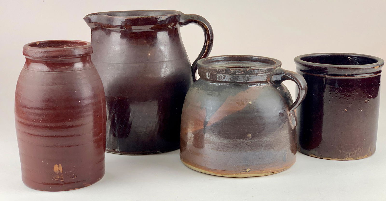 Group of Redware Jugs: Including a pitcher, and three jars. Largest ht. 9.5".