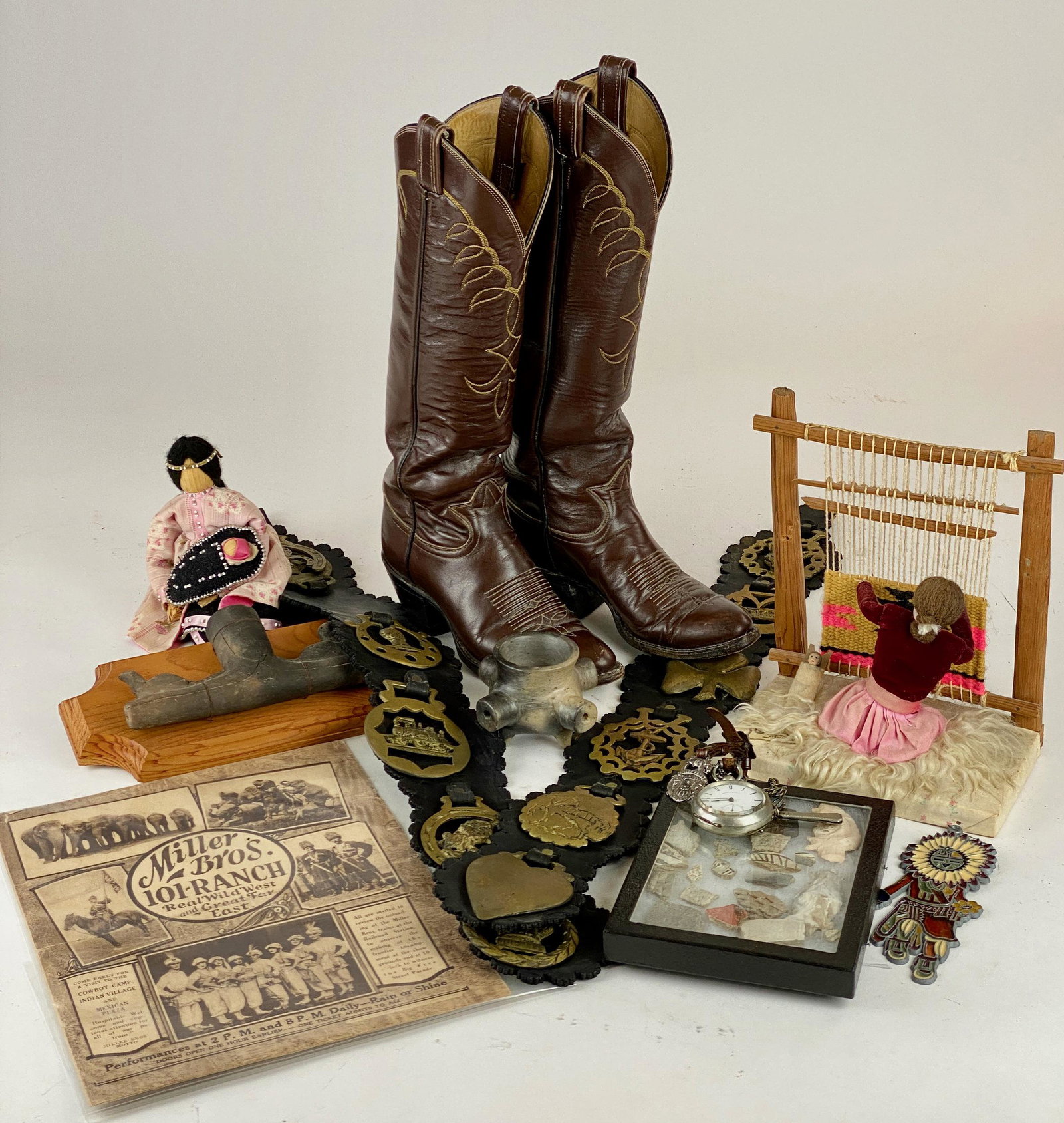 Large Collection of Southwestern Material: Including one pair of leather cowboy boots, one Miller Brothers Ranch magazine, two pipes, two dolls, one collection of pottery shards and arrowheads, two belts with brass buckles and one large Americ