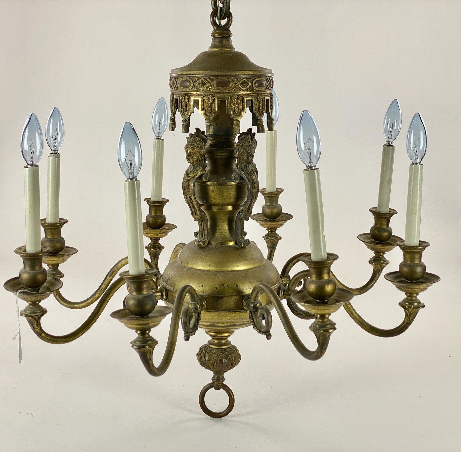 Brass Moorish Style Chandelier: An eight light chandelier of a North African inspired design, with chain. Ht. of chandelier 24" and 26" wd.