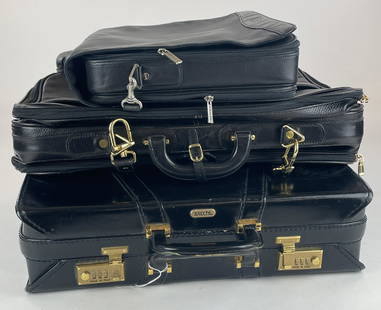 2 Satchi Leather Briefcases and Bally Leather Bag: Three Men's Briefcases, each in black leather, including a pair by Satchi, one with combination lock, and lastly a large Bally men's leather traveling case. Largest 20" x 15"