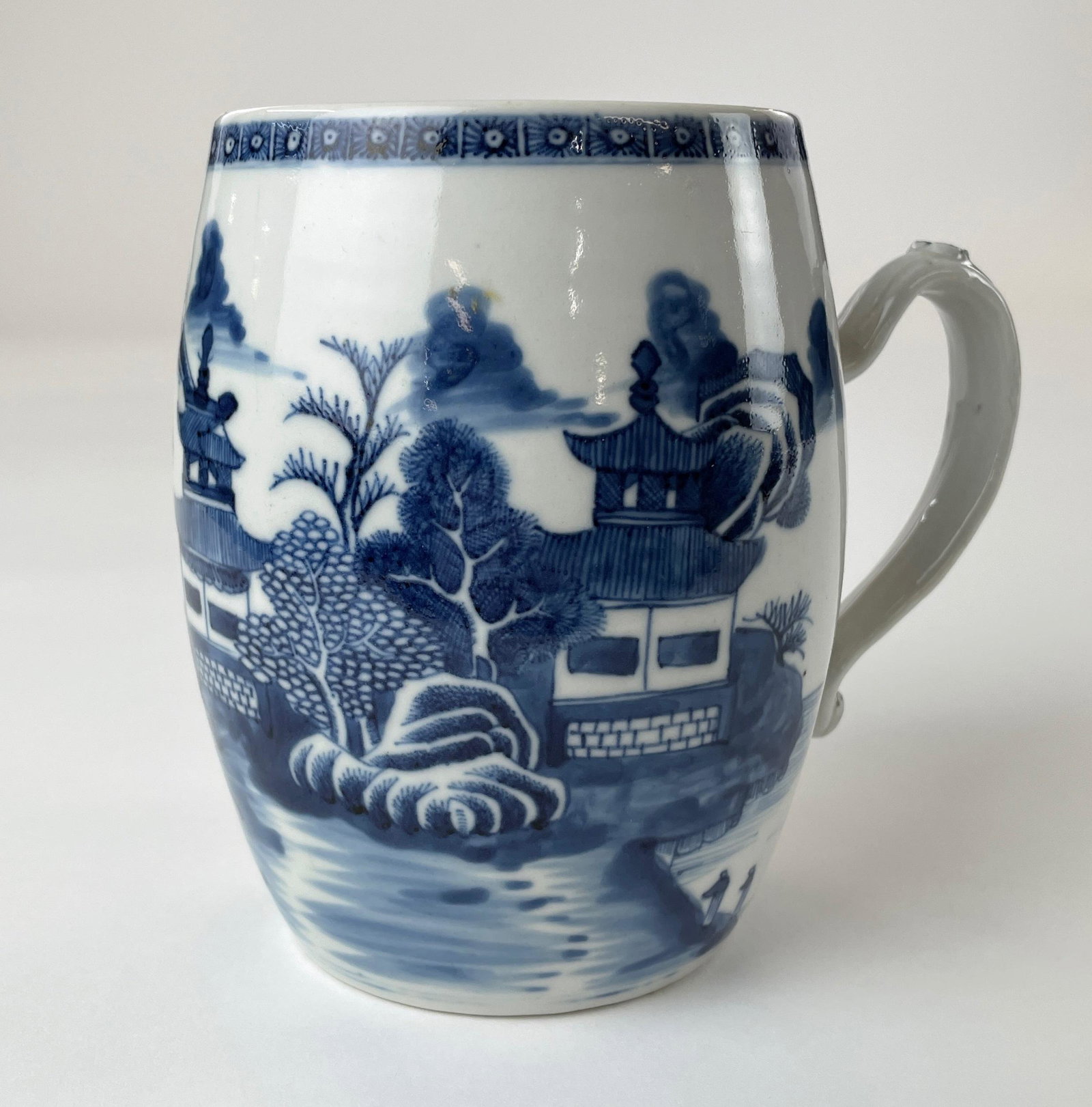 Chinese Blue and White Nanking Export Mug: Chinese, a porcelain mug with blue and white decoration to body, handle with ruyi head in underglaze blue. Ht. 5.75".