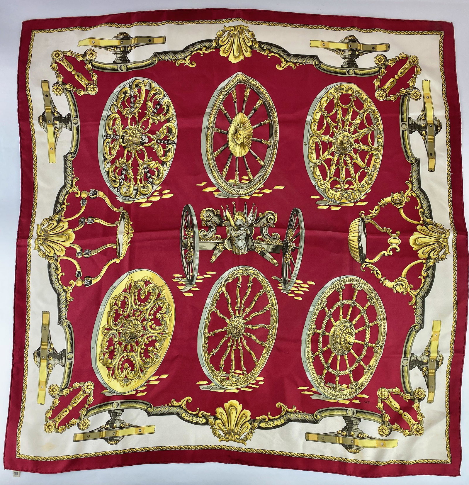 Hermes Silk Twill Red "Caty" Scarf: Depicting a knight in center surrounded by intricate wheels. Size: 34" ht. x 34" wd. From the collection of prominent art historian and lecturer, Robert Allen, New York. Many items featured in "Archit