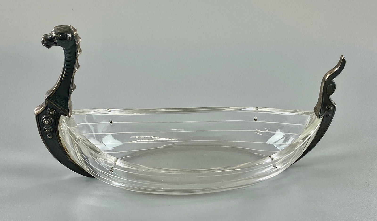 Glass and Sterling Viking Boat: Early to mid 20th century, a glass serving boat with sterling handles, all in the form of a Viking ship. Lg. 9".