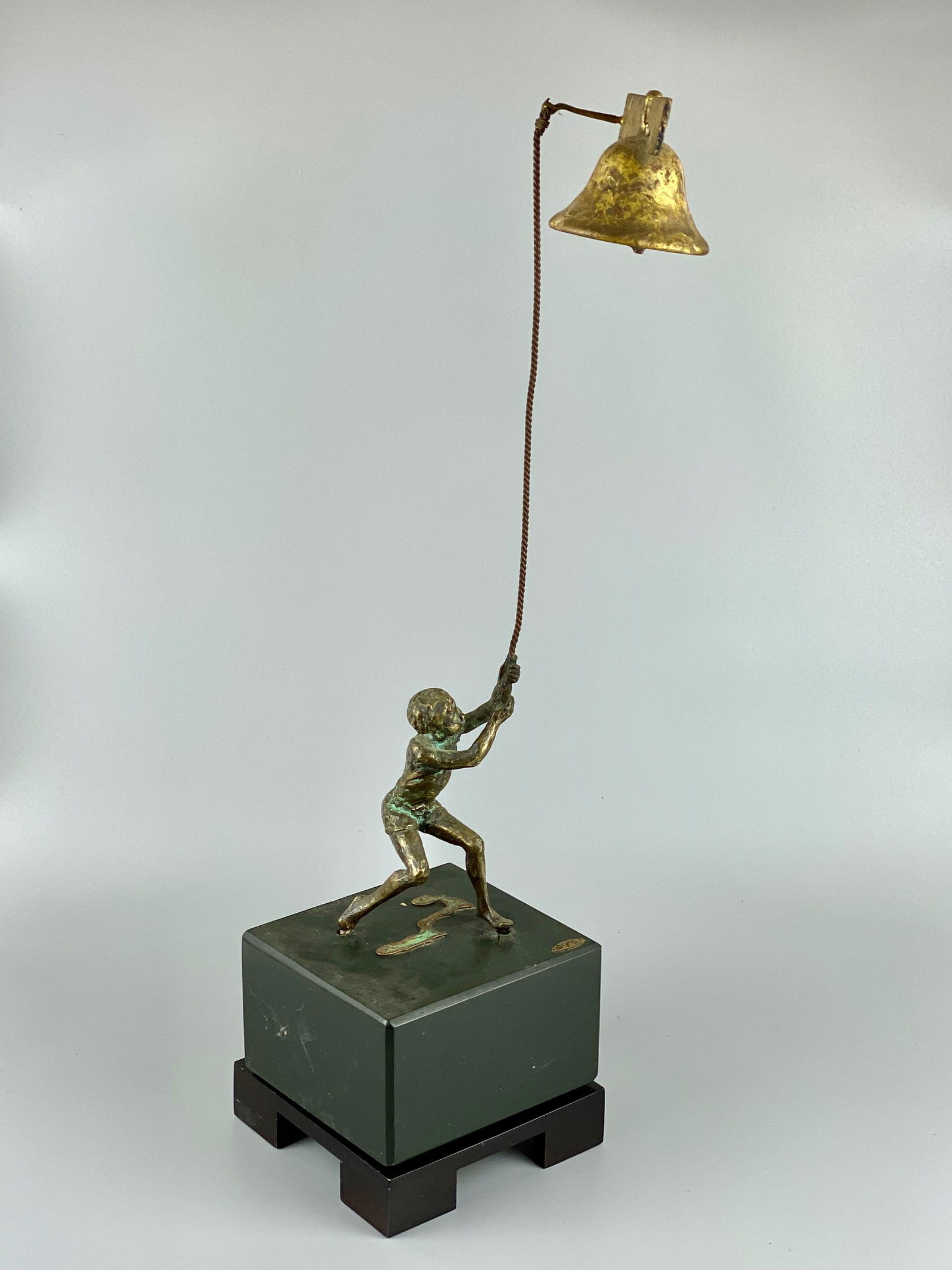 Curtis Jere Bronze Boy with Bell: Bronze, a figural group of boy with bell, all atop pair of wood stands. Ht. 21.5".