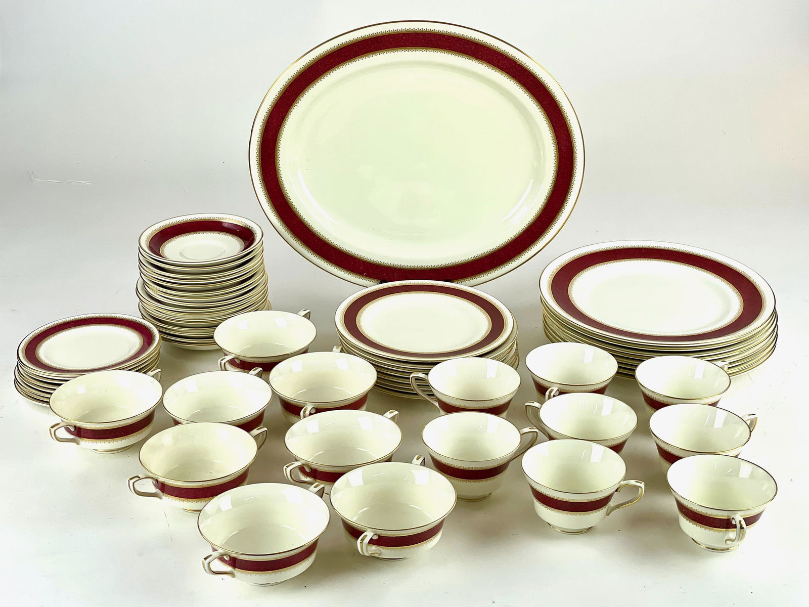 Royal Worcester "Belvoir" China Service: A group of tea and saucers (8 cups), sugars (8), platter, and dinner plate (8), and salad plates (7), and saucers (16).