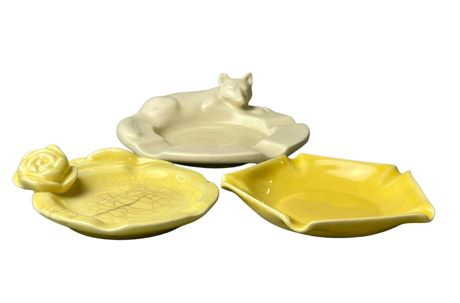 Three Rookwood Ashtrays: Including a fox ashtray, and a pair of smaller yellow examples. Largest diameter