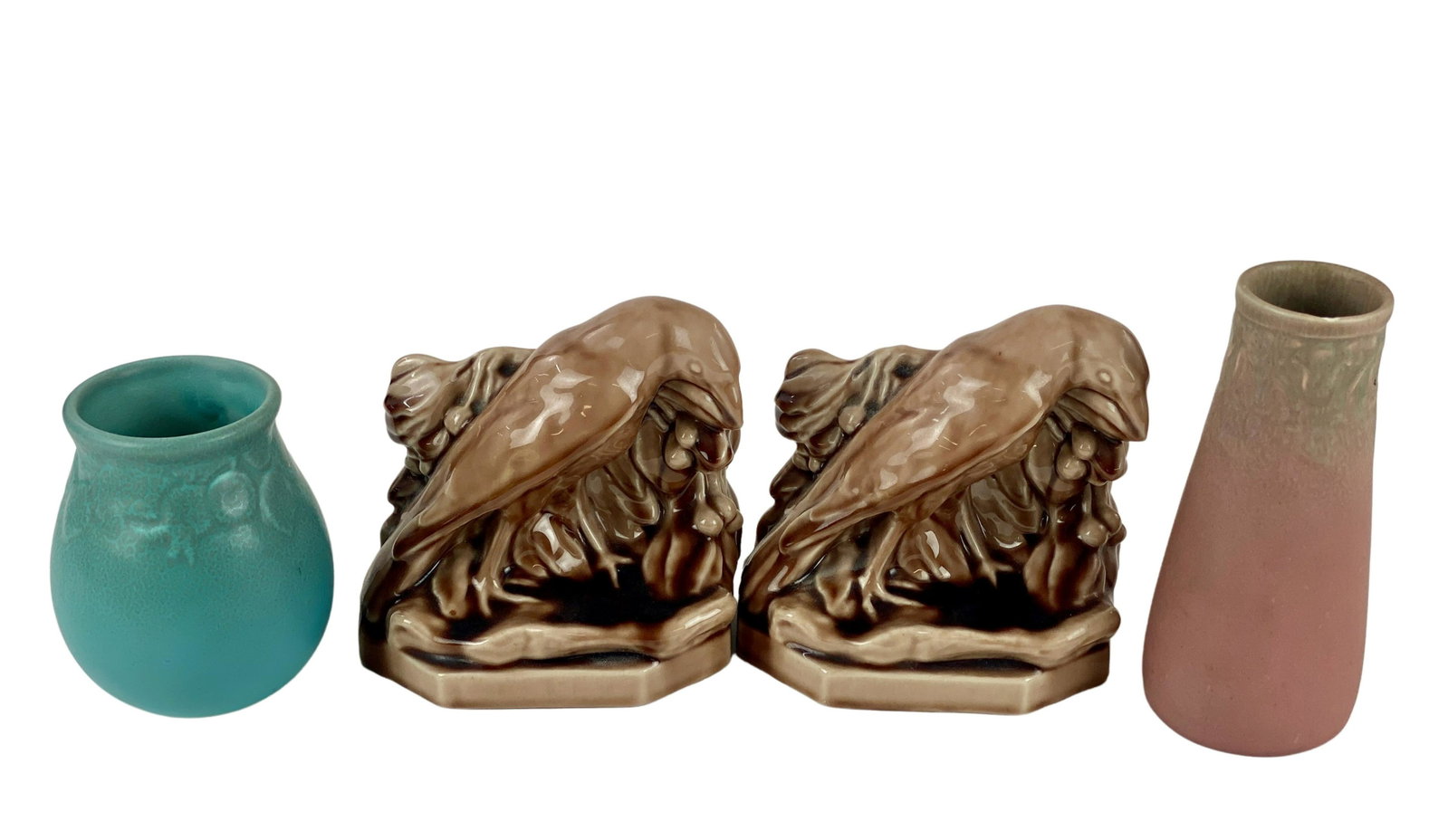 Collection of Four Rookwood Pottery Pieces: Including two matte vases and a pair of crow brown glazed bookends. Crow bookends are 5.5" ht., larger rose colored vase is: 6.5" ht.