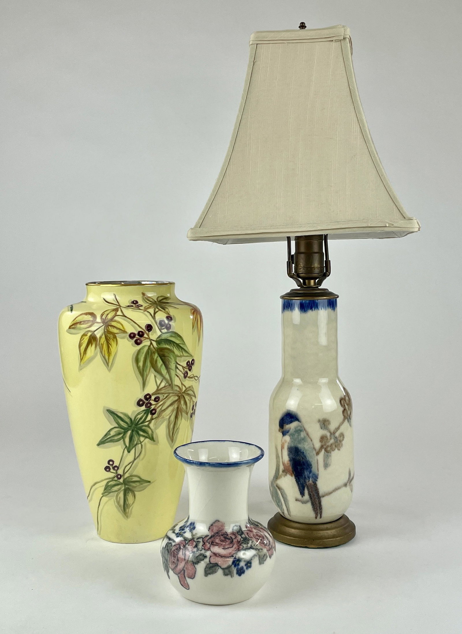 Collection of Three Art Pottery Pieces: One lamp, one smaller vase with minor crazing and one larger yellow vase Belleek vase. Tallest height is lamp at 22" ht.