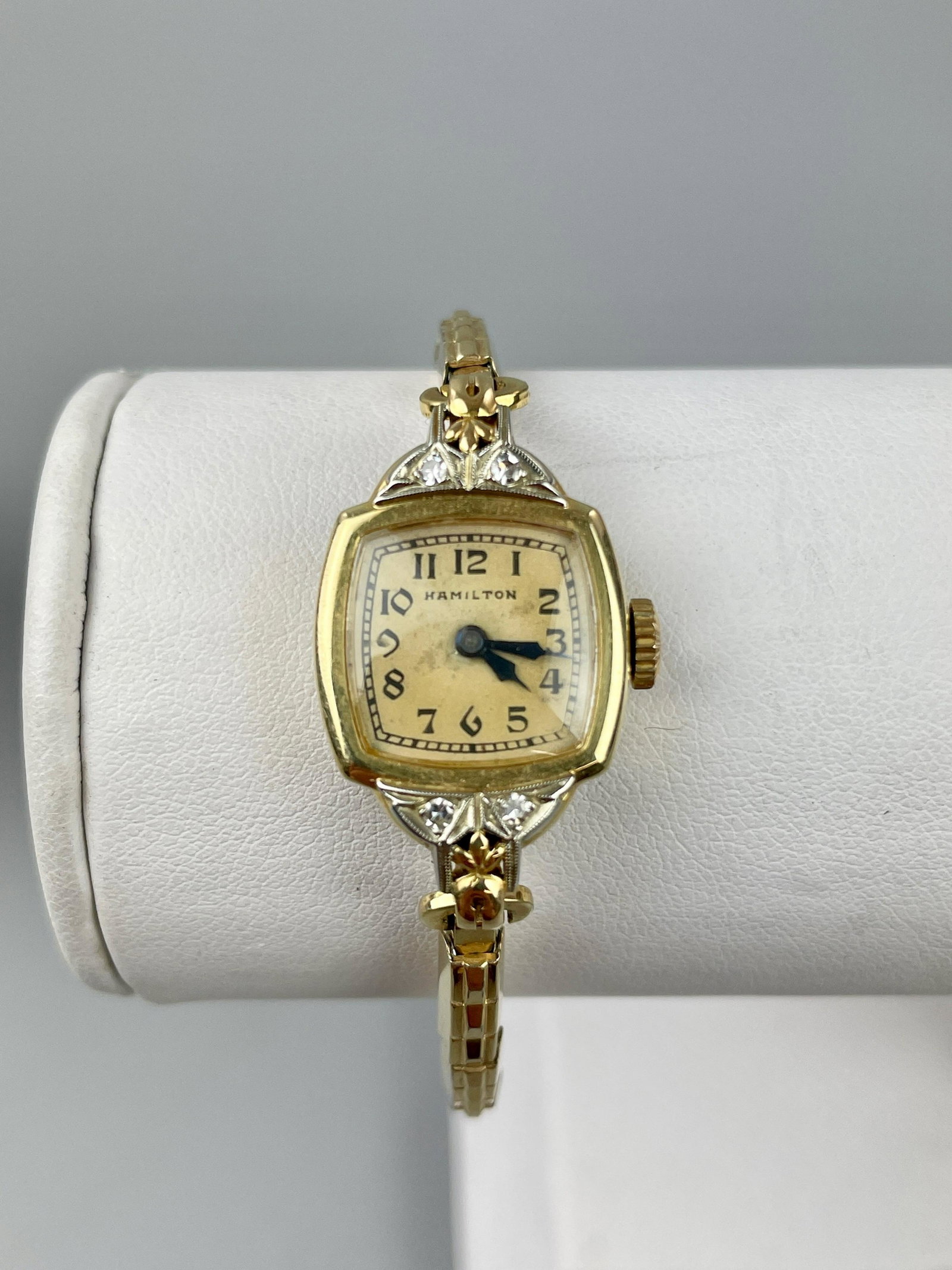 Hamilton 14K Ladies Wristwatch: A Hamilton ladies wristwatch in 14k, marked to reverse, with 4 small diamonds. Total weight 15.8 grams.