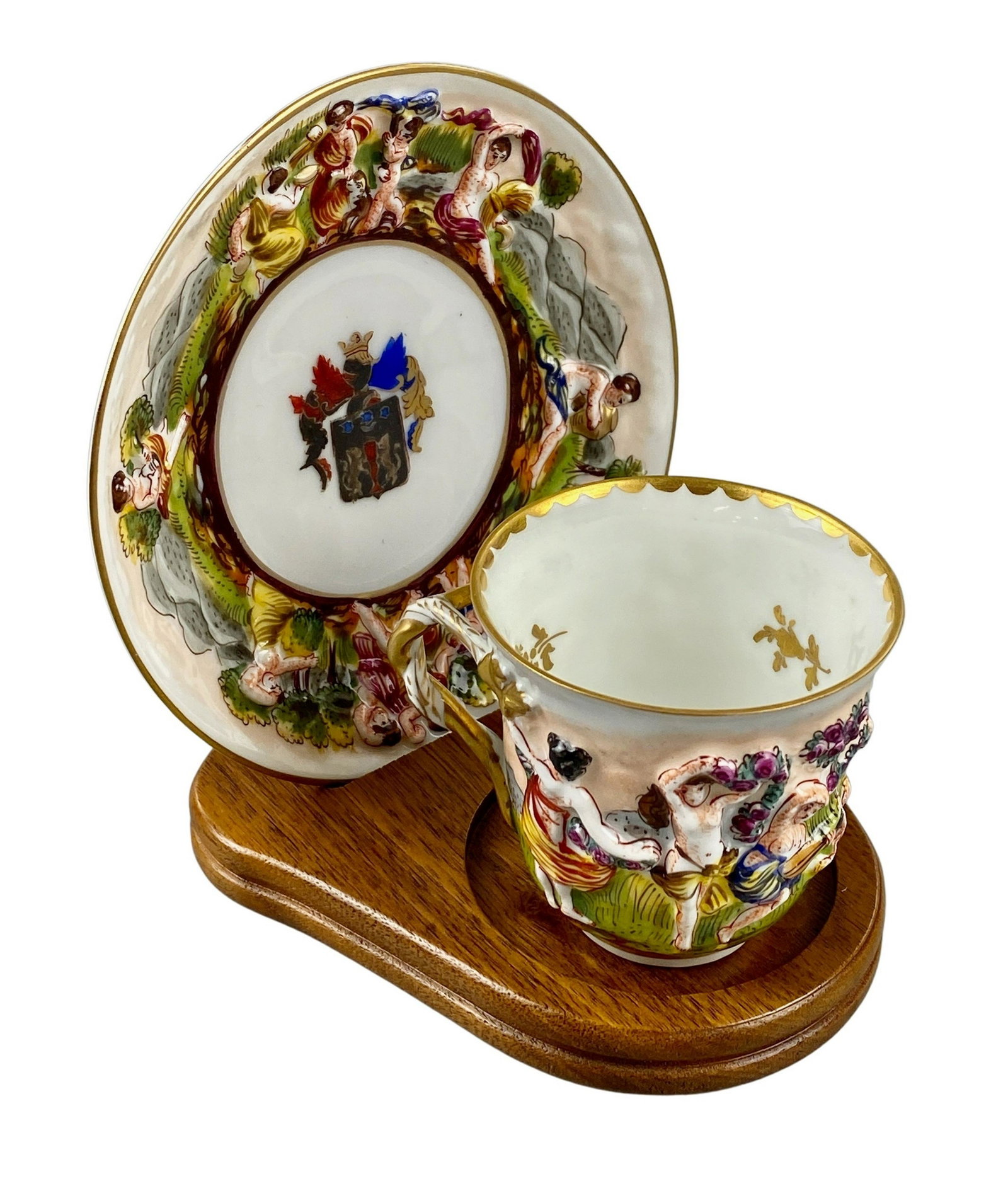 Capodimonte Porcelain Teacup and Saucer: 19th century, with teacup and saucer in relief decoration, some gilt applied.
