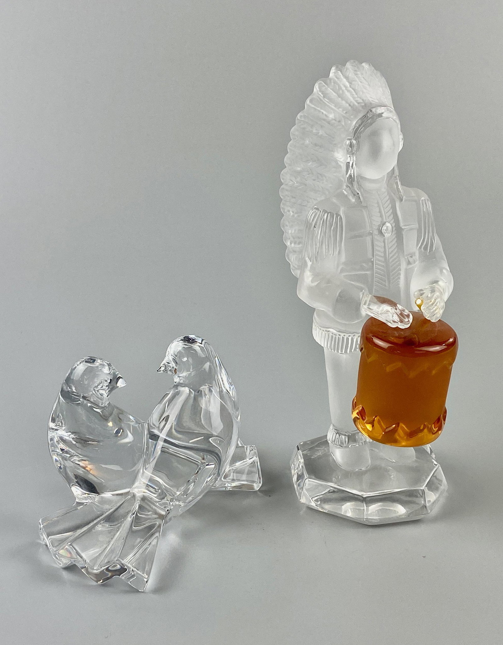 Pair of Crystal Figures, Baccarat and Saint Louis: A Saint Louis crystal Indian drummer, and Baccarat pair of doves. Both signed to undersides. Indian is 6" ht.