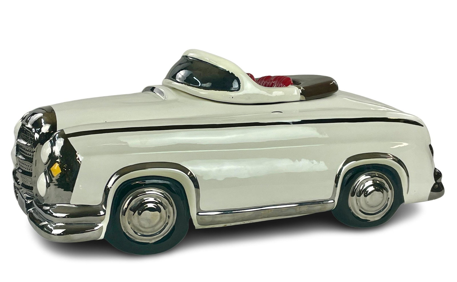 Glenn Appleman Signed Convertible Cookie Jar: Two piece cookie jar car by Glenn Appleman, signed to the underside and dated 1984, also with artist label. A red vinyl seated roadster convertible. 17.5" lg. x 8" ht.