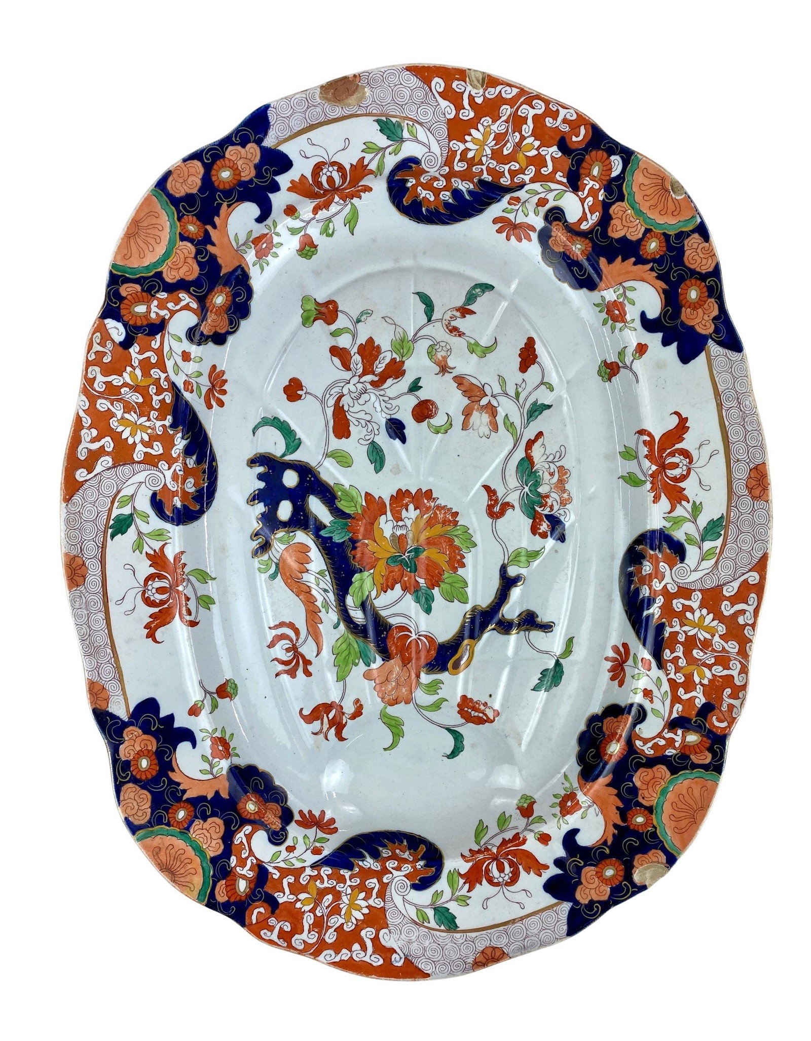 Large Ironstone China Platter: Marked "Ironstone China" to underside. A large charger with floral decoration and one depressed area on right side for catching the flow of juices. Diameter: 21.5" wd.