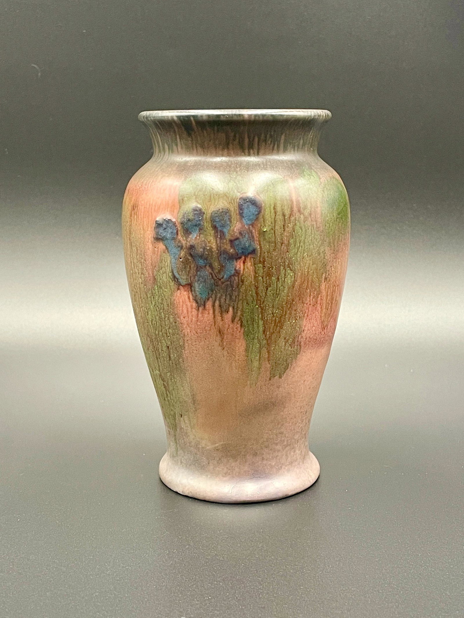 Vera Tischler for Rookwood Pottery: Wax matte glaze, raised blue decoration and signed VT to bottom with Rookwood stamp. 6.5" ht.