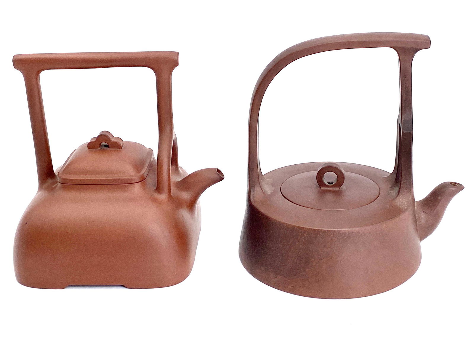 Pair of Chinese Yixing Teapots with Seals: A pair of Yixing ware teapots with tall handles, each marked to undersides and under lids. Tallest ht. 6.5". From the Estates of Reiko (Sakag