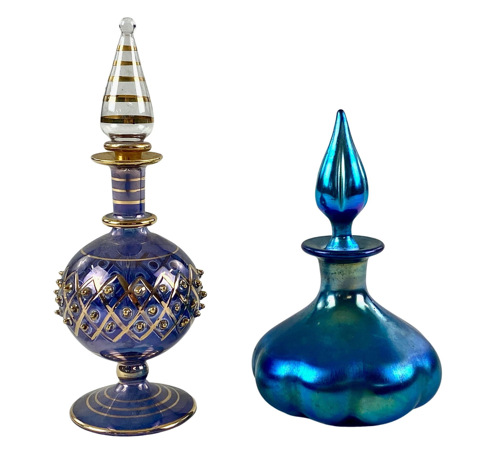 Pair of Inkwells, Including Steuben: One Steuben Aurene turquoise inkwell and one Egyptian glass inkwell. Tallest height: 5.5". From the estate and lifelong collection of William Garrett Hodges (1946-20