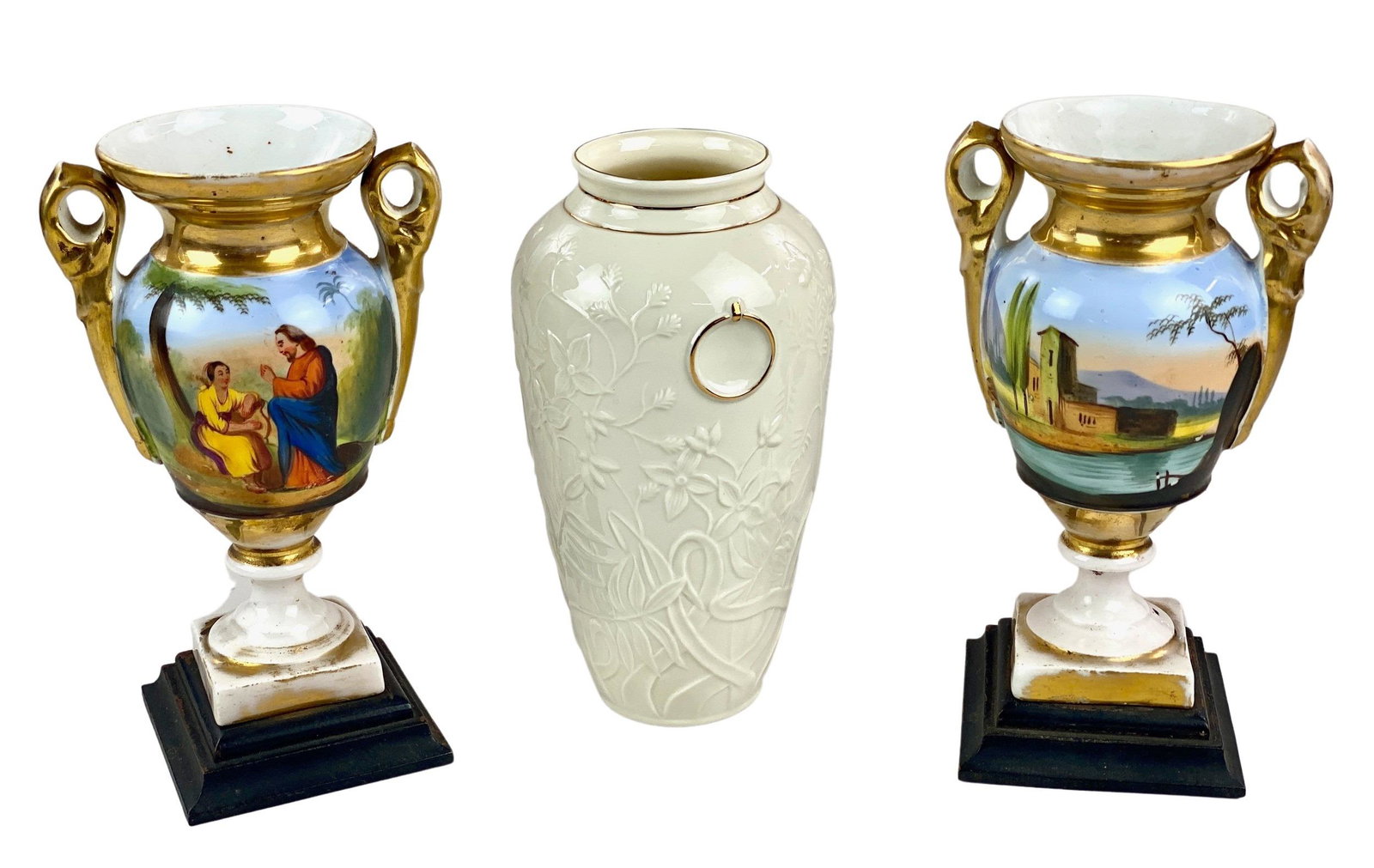 Trio of Three Vases: Including two decorated French urns on bases, and one Belleek Papillion Vase. Tallest height: 8.75". From the estate and lifelong collection of William Garrett Hodge